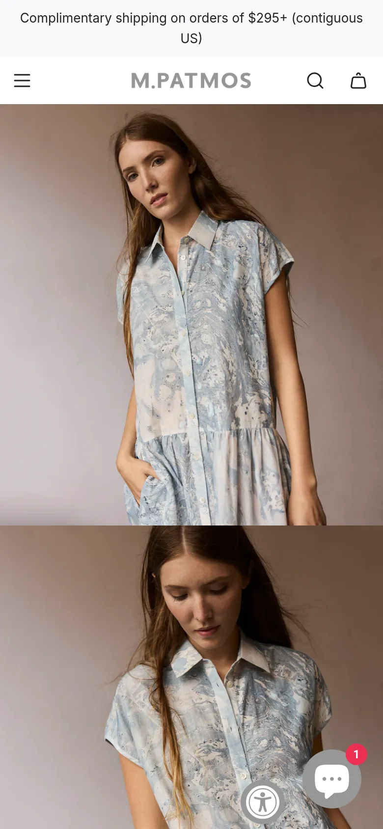 The mobile version maintains the minimalist aesthetic but uses a condensed header with a hamburger menu, search icon, and shopping bag icon. The hero image of the woman in the blue patterned dress is stacked vertically to fit the narrow screen. A floating chat icon and an accessibility icon appear in the bottom right corner.