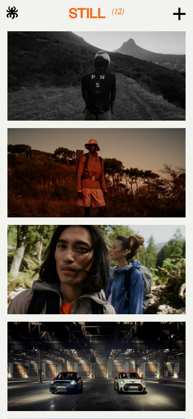 The mobile version presents a single-column vertical stack of the same cinematic campaign images. The header is simplified with a black logo on the left, orange 'STILL (12)' text in the center, and a plus icon on the right, ensuring the imagery remains the primary focus on a smaller screen.