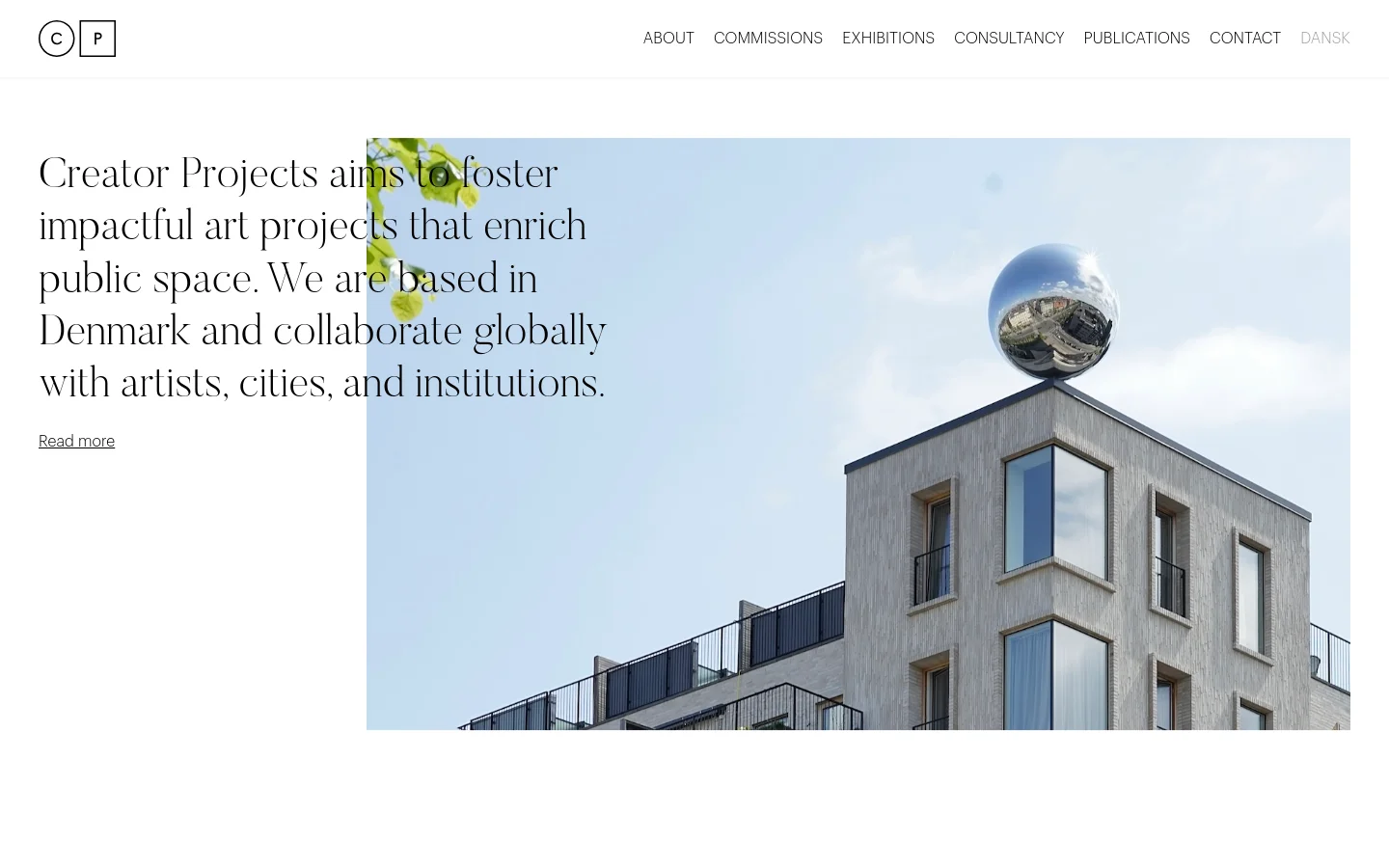 The desktop homepage features a minimalist white layout with a top navigation menu including links like About, Commissions, and Exhibitions. A large hero section displays a high-angle photograph of a modern building with a reflective sphere on the roof, overlaid with a serif headline about fostering impactful art projects and a 'Read more' link.