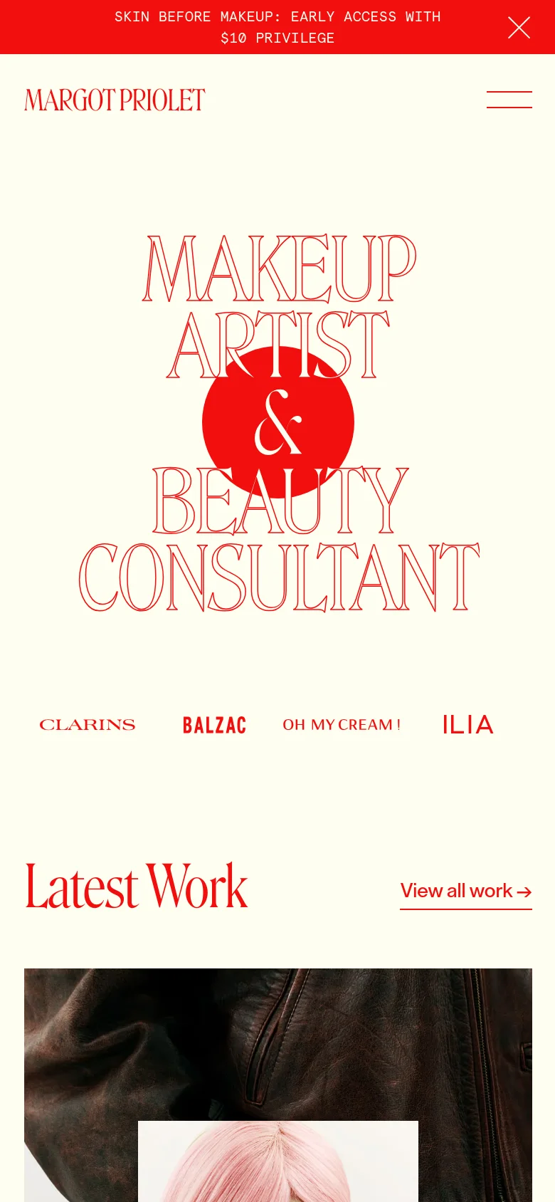 The mobile version maintains the cream and red color scheme but uses a condensed layout with a hamburger menu icon in the top right. The large central typography and red circle are scaled down to fit the vertical screen, and the 'Latest Work' section begins below the hero area with large image tiles.