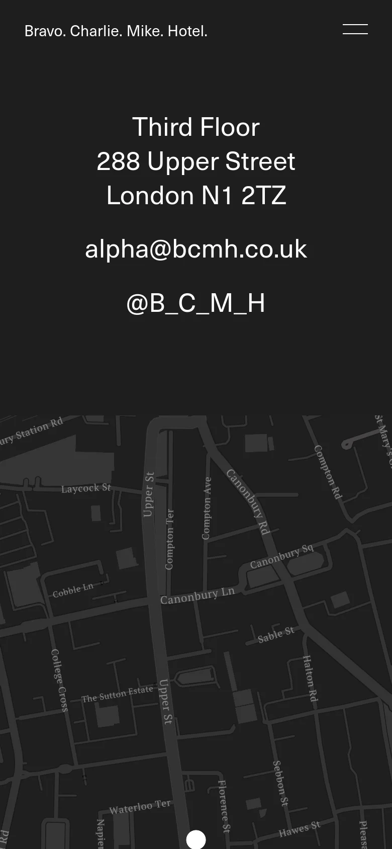 The mobile version maintains the dark, minimalist aesthetic and centered white typography. The layout is vertically stacked, showing the contact details followed by the map, which fills the width of the mobile screen.