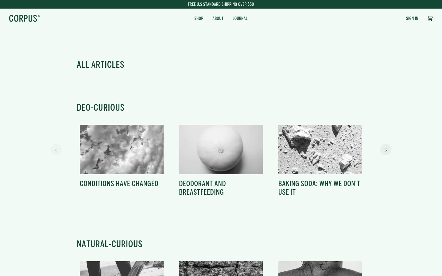 The desktop Journal page features a clean, minimalist layout with a light gray background and dark green text. Articles are organized into horizontal scrolling carousels under headings like 'DEO-CURIOUS' and 'NATURAL-CURIOUS', each displaying a large grayscale image above its title.