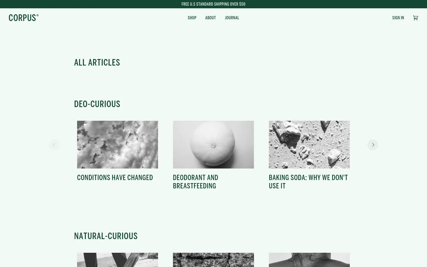 The desktop Journal page features a clean, minimalist layout with a light gray background and dark green text. Articles are organized into horizontal scrolling carousels under headings like 'DEO-CURIOUS' and 'NATURAL-CURIOUS', each displaying a large grayscale image above its title.