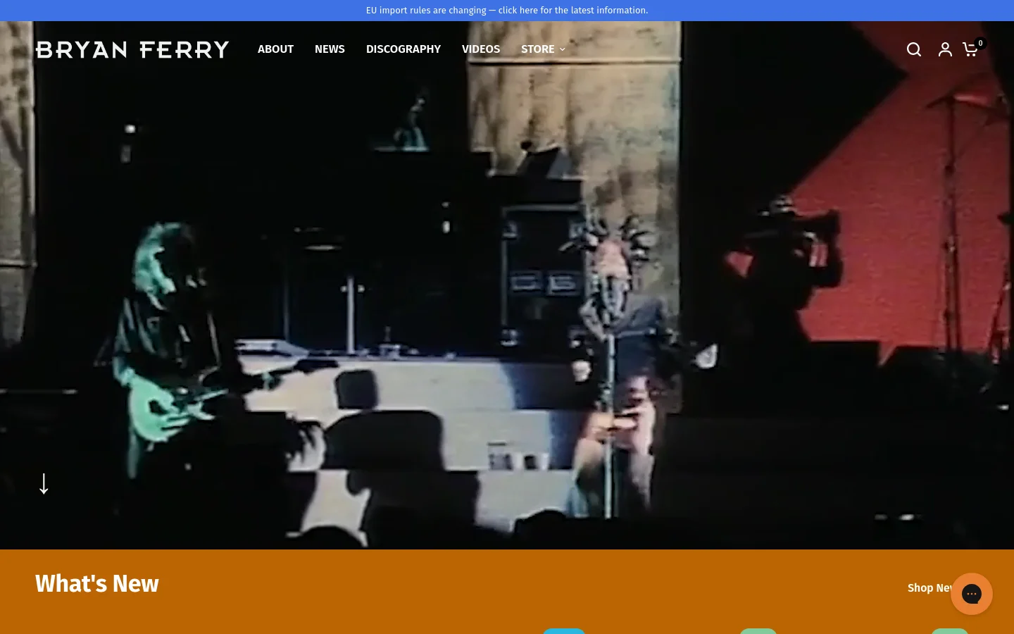 The desktop homepage features a large cinematic hero video of a musical performance with a dark, moody aesthetic. A white navigation bar at the top includes the Bryan Ferry logo, links for About, News, Discography, Videos, and Store, alongside search and cart icons. Below the hero section, a bright orange 'What's New' banner introduces a product grid showcasing apparel and vinyl records.