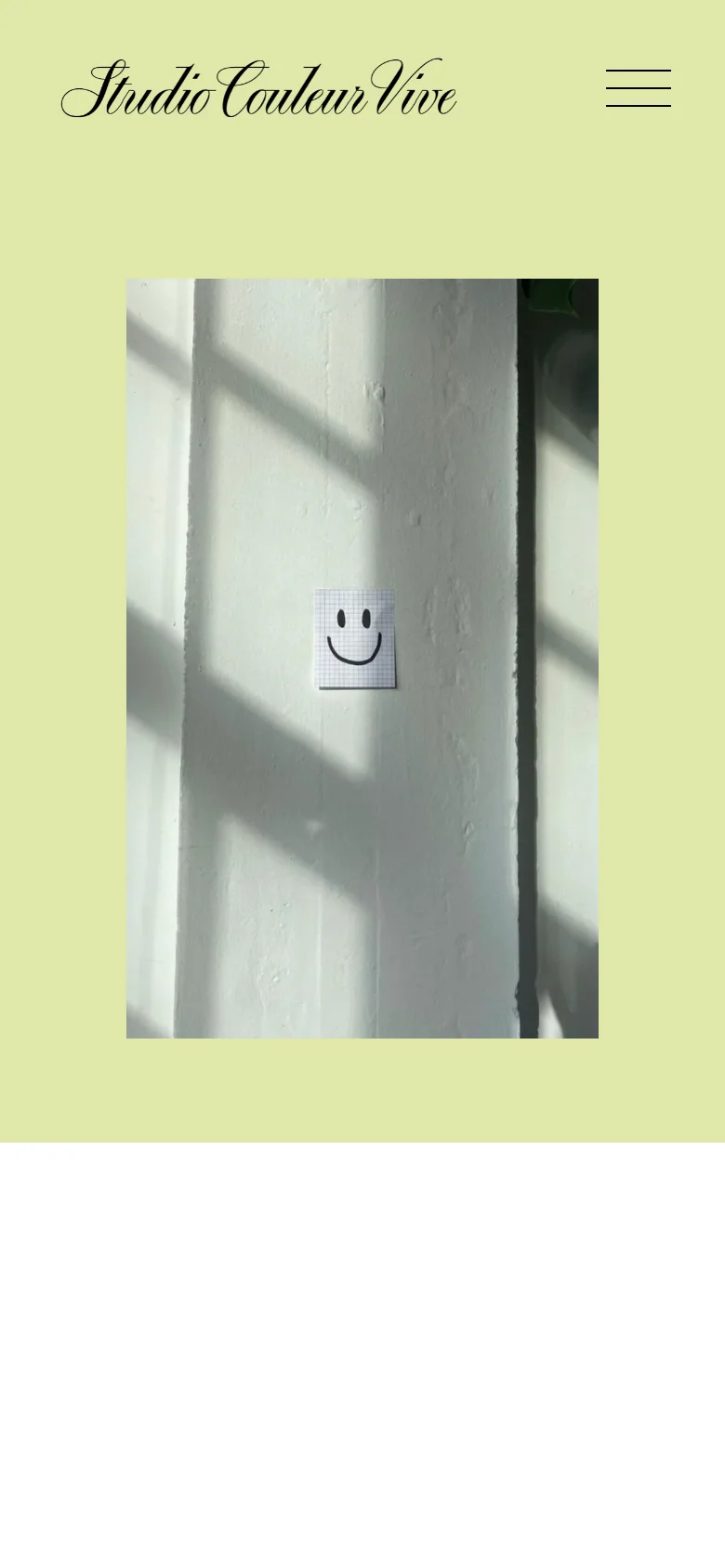 The mobile version maintains the lime green background and the script logo but uses a hamburger menu icon for navigation instead of a text list. The central hero image of the smiley face on a white wall remains the focal point, scaled to fit the vertical screen.