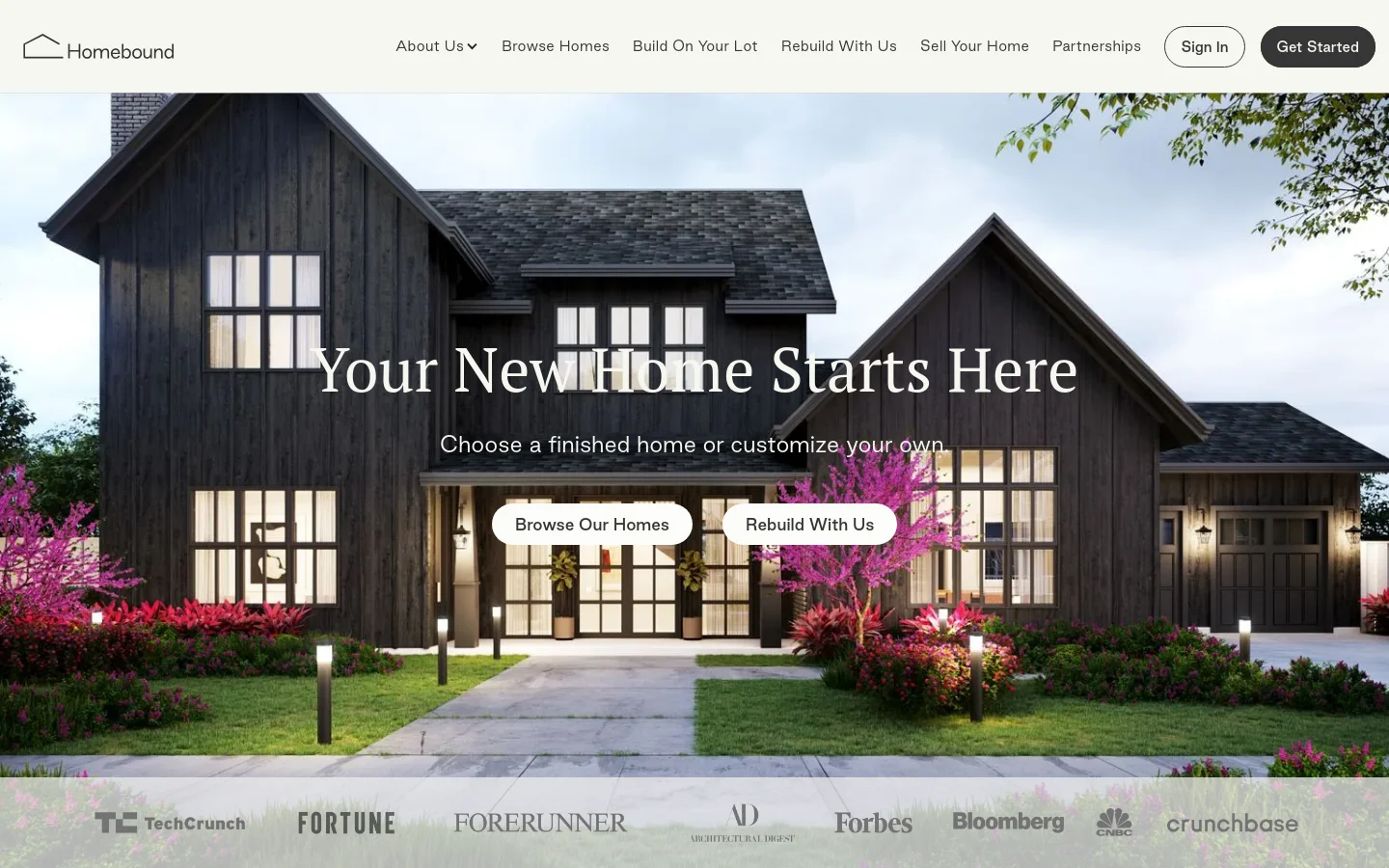 The desktop homepage features a large hero image of a modern dark farmhouse at dusk with manicured landscaping. A central headline reads 'Your New Home Starts Here' above two white call-to-action buttons: 'Browse Our Homes' and 'Rebuild With Us'. A white navigation bar sits at the top, and a row of media logos like TechCrunch and Fortune is displayed at the bottom.