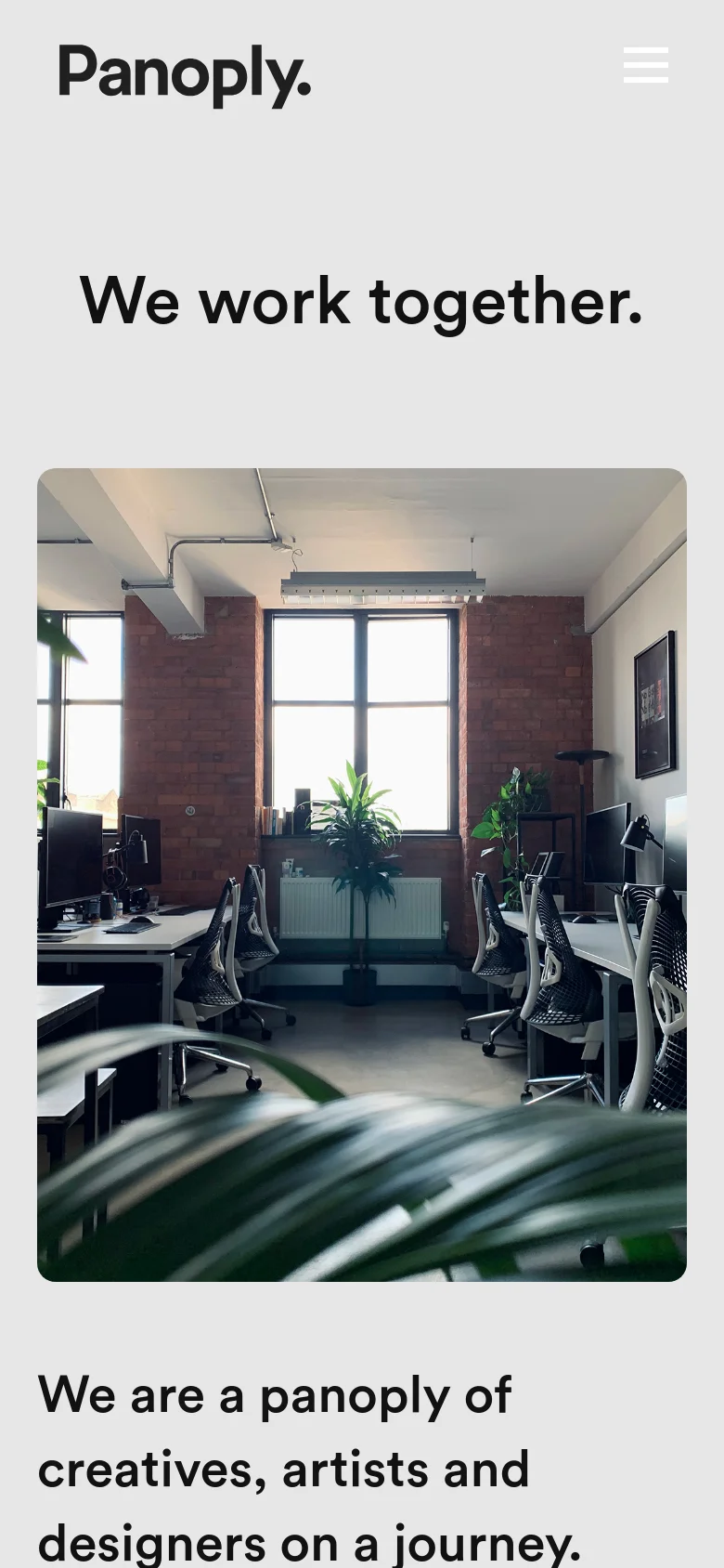 The mobile version uses a similar light gray color scheme but features a condensed layout with a hamburger menu icon next to the Panoply logo. The headline 'We work together' is centered above a large, vertically oriented studio office photograph. The text and contact details are stacked vertically to fit the narrow screen width.