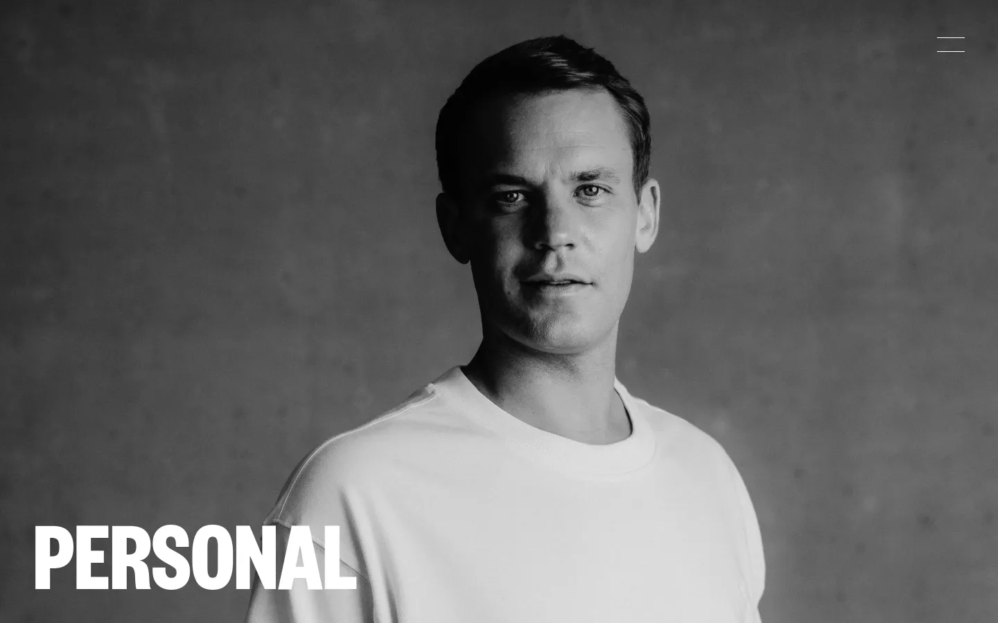 A black and white portrait of Manuel Neuer wearing a white t-shirt against a textured gray background. The large, bold white headline 'PERSONAL' is positioned in the bottom left corner, and a minimalist hamburger menu icon is in the top right.