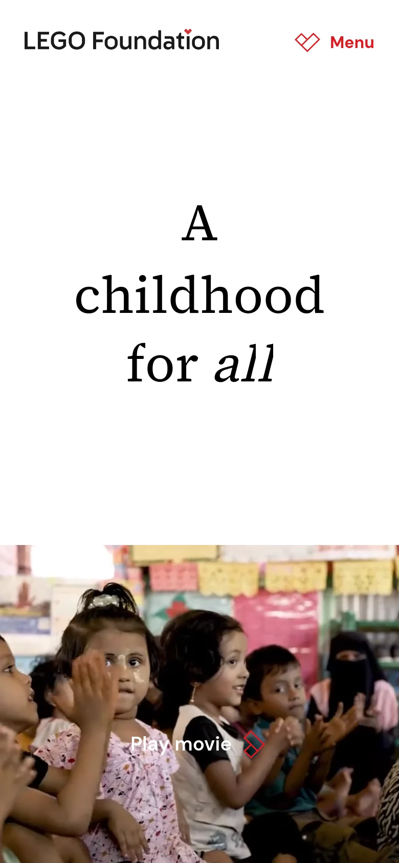 The mobile version simplifies the layout with a centered LEGO Foundation logo and a red 'Menu' icon at the top right. The headline 'A childhood for all' is stacked vertically in large black text. The bottom of the screen features a colorful video thumbnail of children with a prominent 'Play movie' button and red icon.