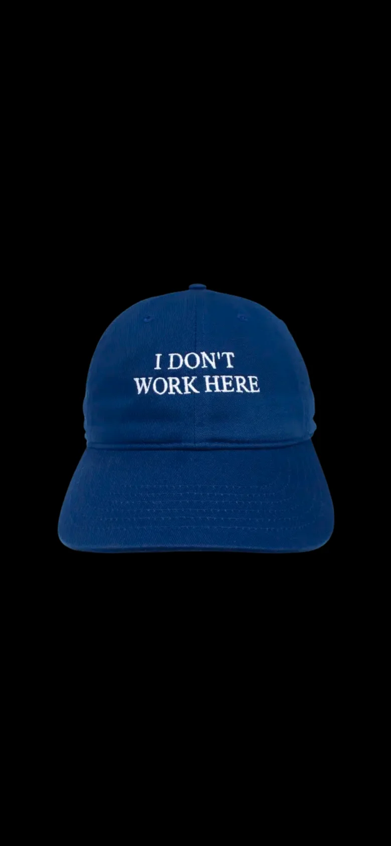 The mobile version maintains the same minimalist aesthetic with a black background. The central focus is the royal blue baseball cap with white text, scaled to fit the narrower vertical screen orientation.