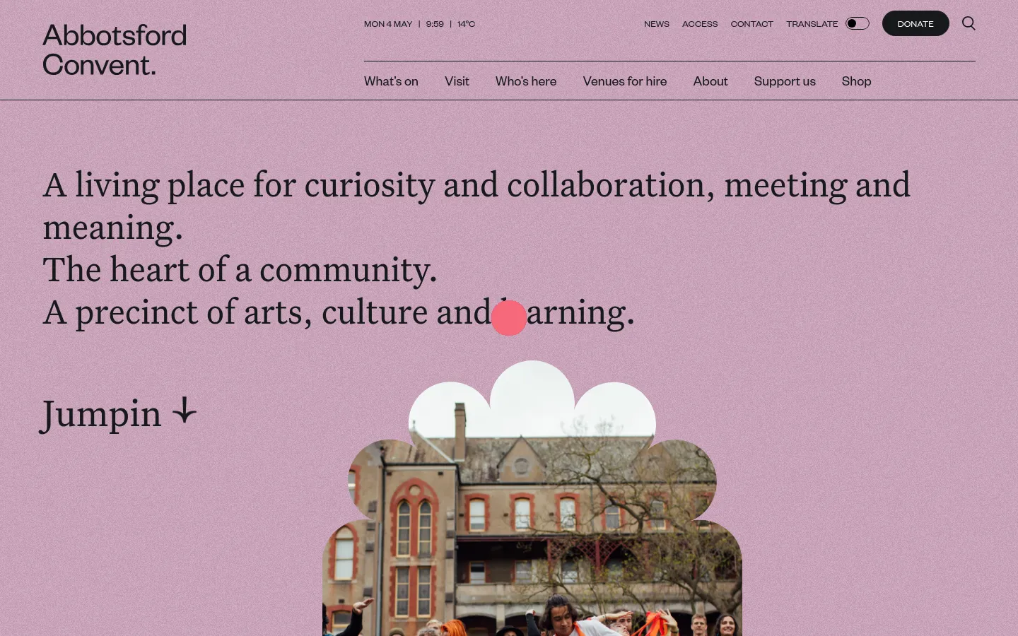 The Abbotsford Convent homepage features a light purple background with large serif typography stating, 'A living place for curiosity and collaboration, meeting and meaning.' Below the text, a 'Jumpin' link with a downward arrow sits above a scalloped-edge photo of people dancing in front of a historic brick building. The desktop header includes navigation links like 'What's on' and 'Visit,' a 'Donate' button, and a search icon.