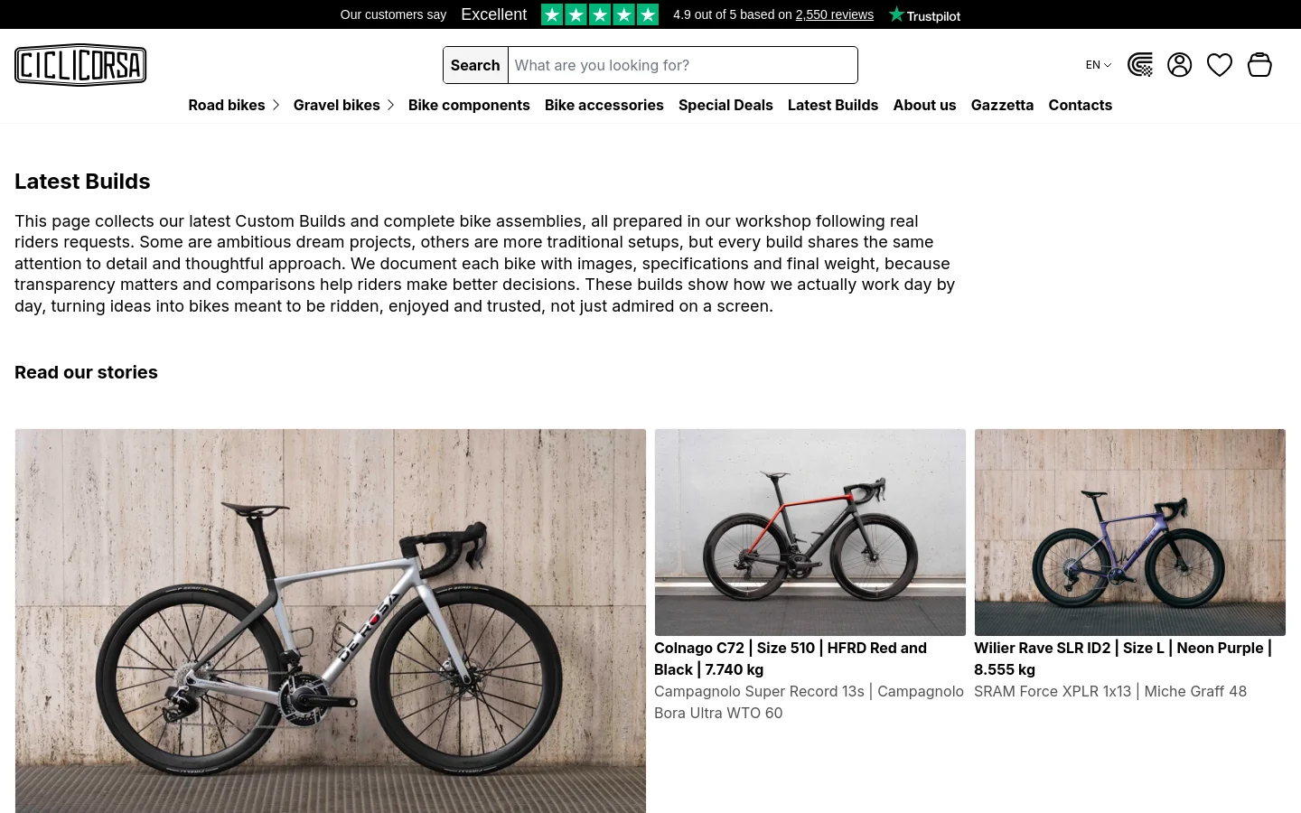 The desktop page features a clean white background with a navigation menu at the top including categories like Road bikes and Gravel bikes. The main content area displays the headline 'Latest Builds' followed by an introductory paragraph and a 'Read our stories' link. Below, a grid of high-quality bicycle photographs showcases custom builds, such as a De Rosa and a Colnago, with detailed text descriptions underneath each image.