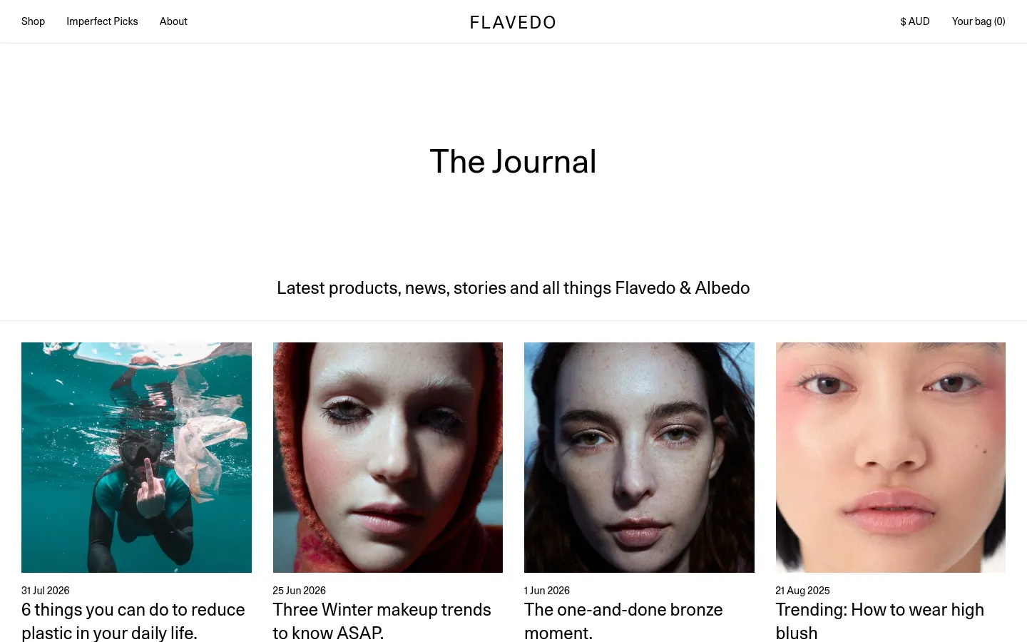 The Journal page features a clean, minimalist white layout with a centered headline and subtext. Below, a grid of blog posts displays large rectangular images, publication dates, and article titles such as '6 things you can do to reduce plastic in your daily life.' The navigation bar at the top includes links for Shop, Imperfect Picks, and About, alongside the Flavedo logo and shopping bag icon.