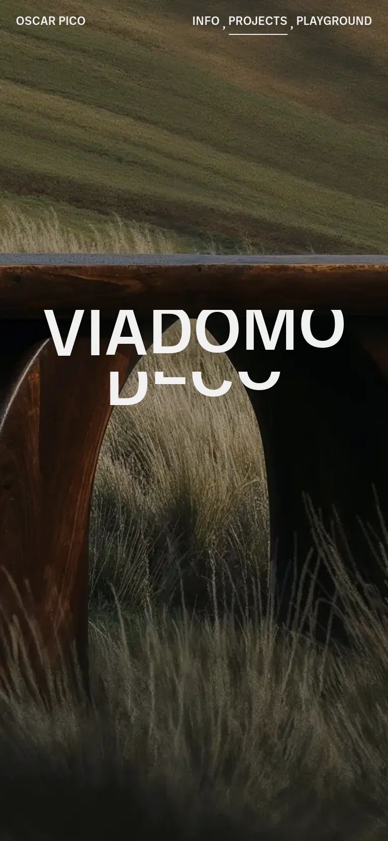 The mobile version presents a vertically cropped version of the hero image, focusing on the wooden structure and tall grass. The typography for 'VIADOMO DECO' is significantly larger and centered, while the navigation links are repositioned at the top to accommodate the narrower screen width.