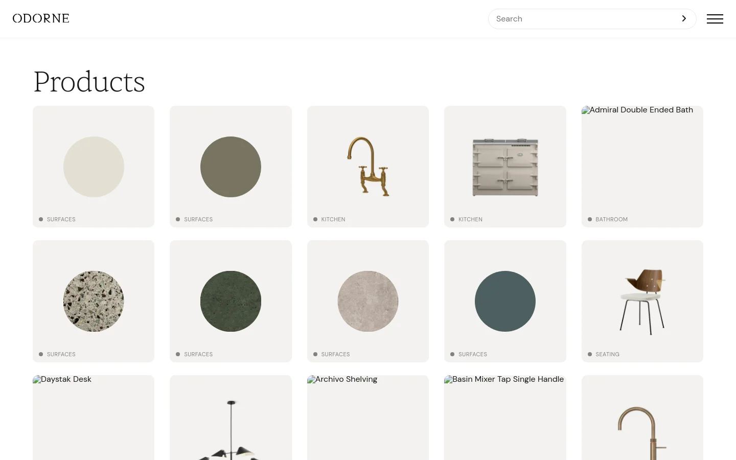 The desktop page features a minimalist design with a white background and the heading 'Products'. A grid of product tiles displays various items like brass taps, kitchen appliances, and stone surfaces, each labeled with a category such as 'Surfaces', 'Kitchen', or 'Seating'.