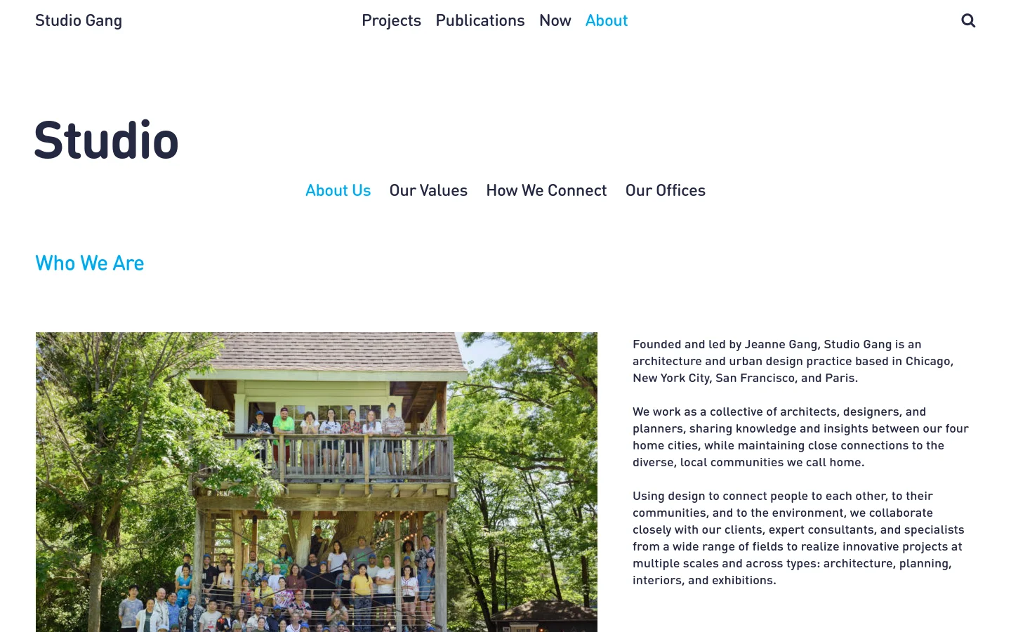The desktop version of the Studio page features a clean, white layout with a top navigation menu including Projects, Publications, Now, and About. The main content displays a large 'Studio' heading, a sub-navigation menu, and a section titled 'Who We Are' which includes a wide group photograph of the team on a wooden balcony surrounded by trees, positioned next to descriptive text.