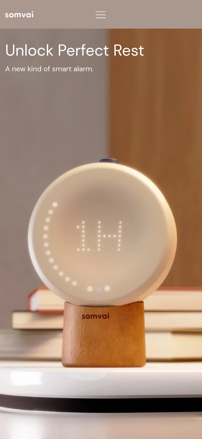 The mobile version uses a vertical layout with the Somvai logo on the top left and a hamburger menu icon on the top right. The hero text 'Unlock Perfect Rest' and its subheadline are stacked above the large image of the Somvai device, which occupies the lower portion of the screen.