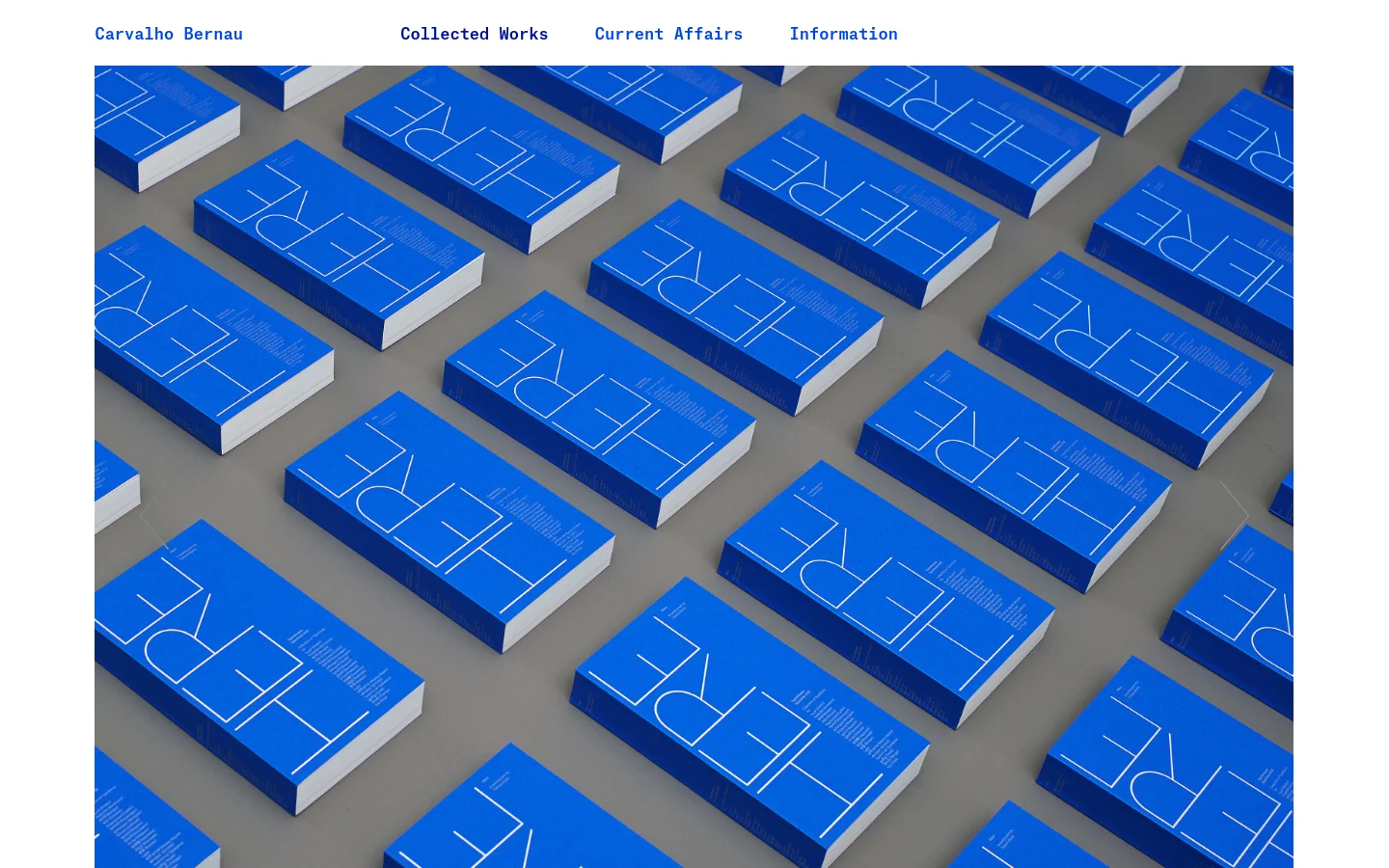 The desktop homepage features a minimalist design with a top navigation bar containing links for Collected Works, Current Affairs, and Information. The hero section displays a large, high-angle photograph of numerous bright blue books with the word 'HERE' printed in white, arranged in a grid on a gray surface. Below the image, a text section describes the 'HERE: A world poem' project.