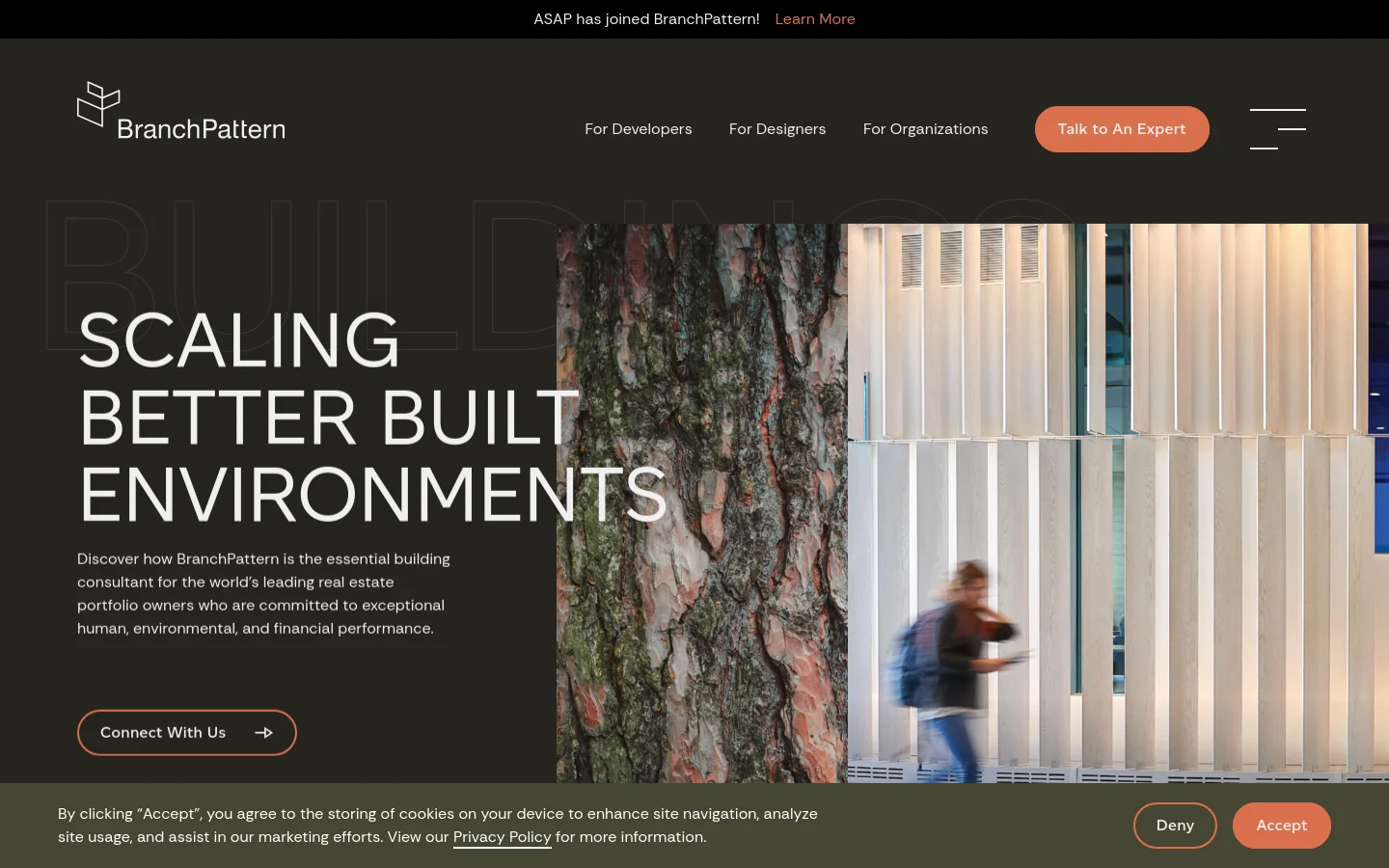 The desktop homepage features a dark theme with a large hero section displaying the headline 'SCALING BETTER BUILT ENVIRONMENTS' over a split image of a tree trunk and a modern building facade. A navigation bar at the top includes links for developers, designers, and organizations, alongside a prominent 'Talk to An Expert' button. A thin announcement bar at the very top highlights news about ASAP joining BranchPattern.