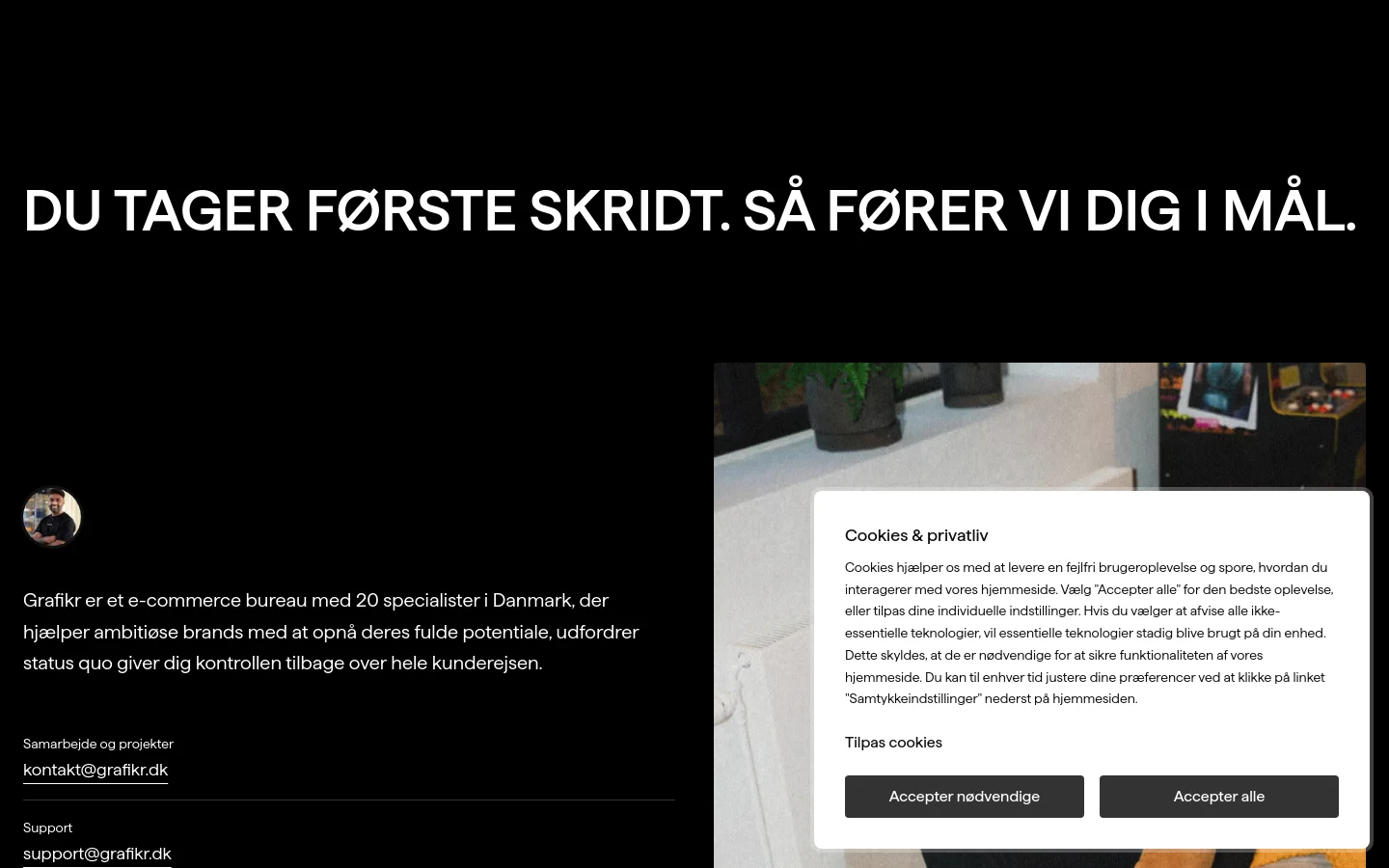 The desktop contact page features a dark theme with large white headline text reading 'DU TAGER FØRSTE SKRIDT. SÅ FØRER VI DIG I MÅL.' A circular profile photo of Kiranan Luxmy is positioned on the left. Contact information including email addresses for collaboration and support, a phone number, and a physical address are listed in white text against the black background.
