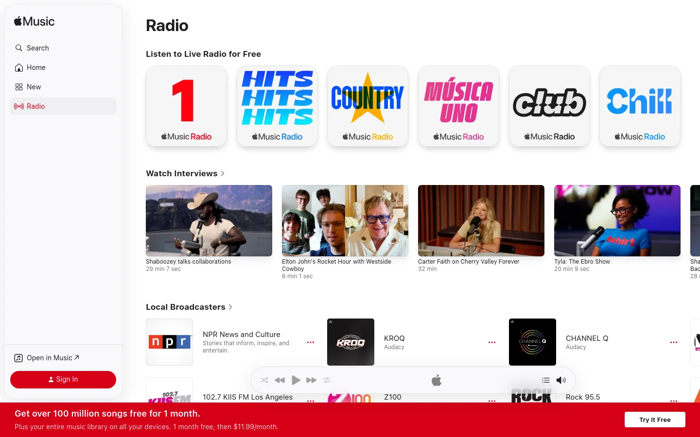 The Apple Music Radio desktop page features a clean white layout with a sidebar navigation menu on the left. The main content area displays a large 'Radio' headline, followed by a row of colorful square tiles for various radio stations like Hits, Country, and Club. Below this, a 'Watch Interviews' section shows video thumbnails of musical artists, and a 'Local Broadcasters' section lists radio stations with their logos.