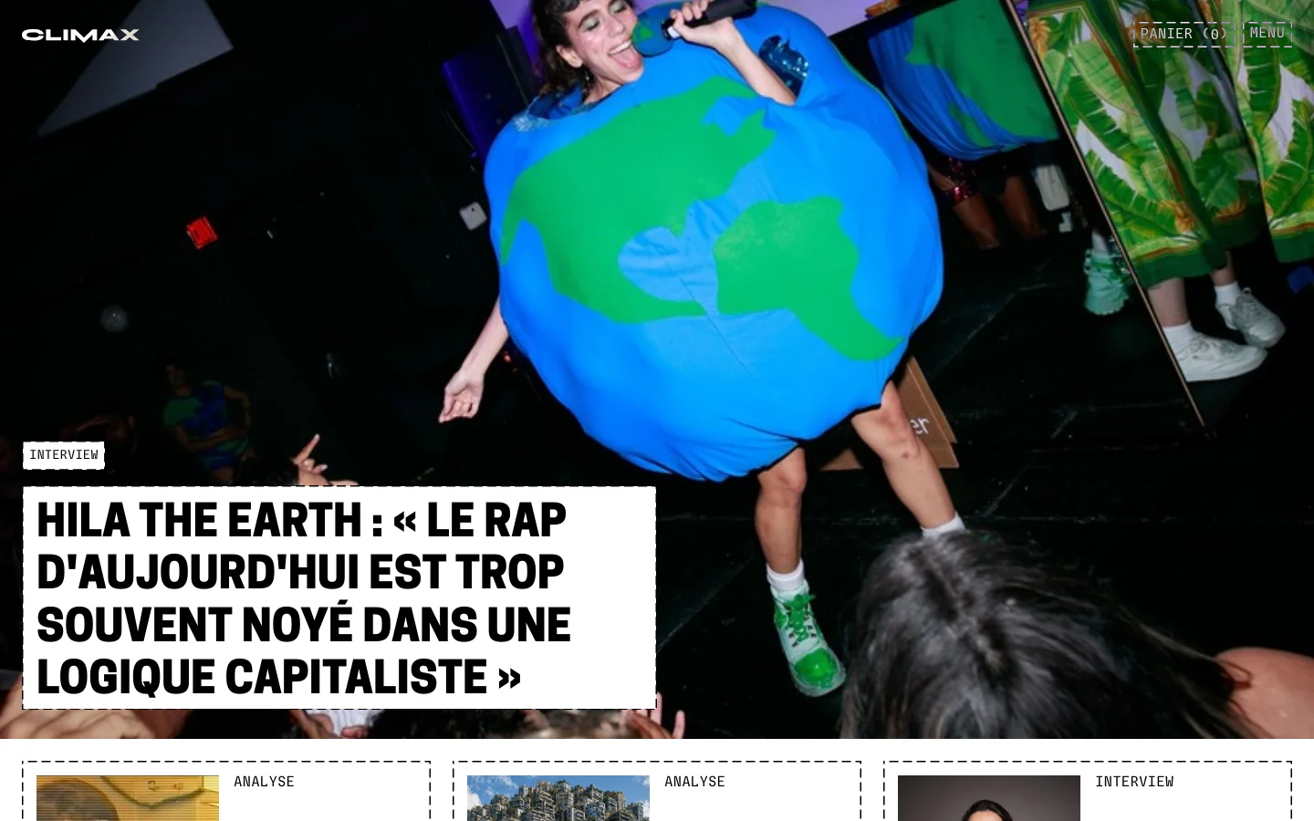 The Climax Zine homepage features a large hero image of a person in an Earth costume performing on stage, with a bold white headline overlay. Below the hero section, a grid of recent articles is displayed with large thumbnail images, category tags like 'Analyse' or 'Interview', and headlines. The layout is clean with a dark background and a navigation bar at the top containing the logo, a shopping cart, and a menu button.