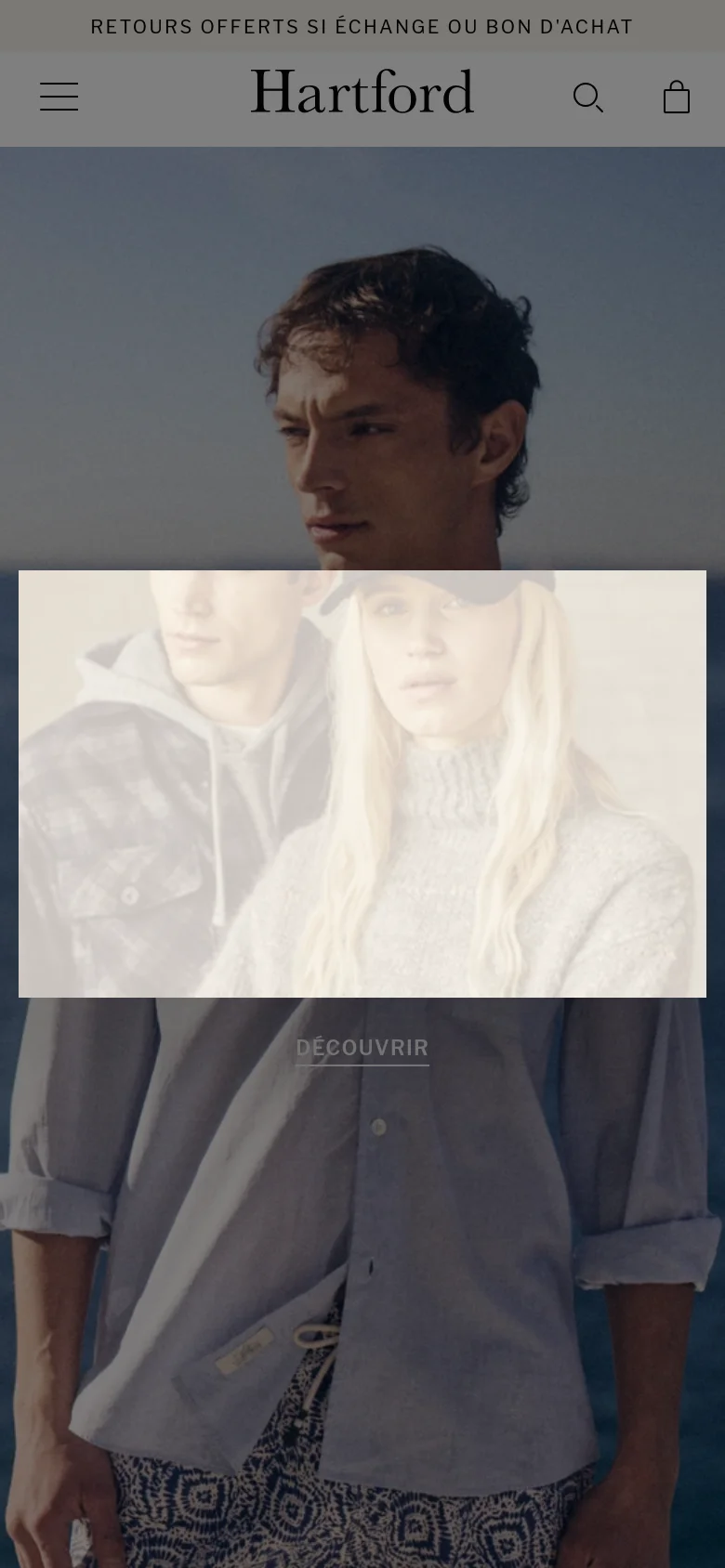 The mobile version presents a vertically stacked layout, starting with a large hero image of a man by the sea and a centered 'DÉCOUVRIR' button. The navigation is condensed into a hamburger menu on the left, with the Hartford logo centered and search and shopping bag icons on the right. Content sections like product grids and collection banners follow in a single-column scrollable format.