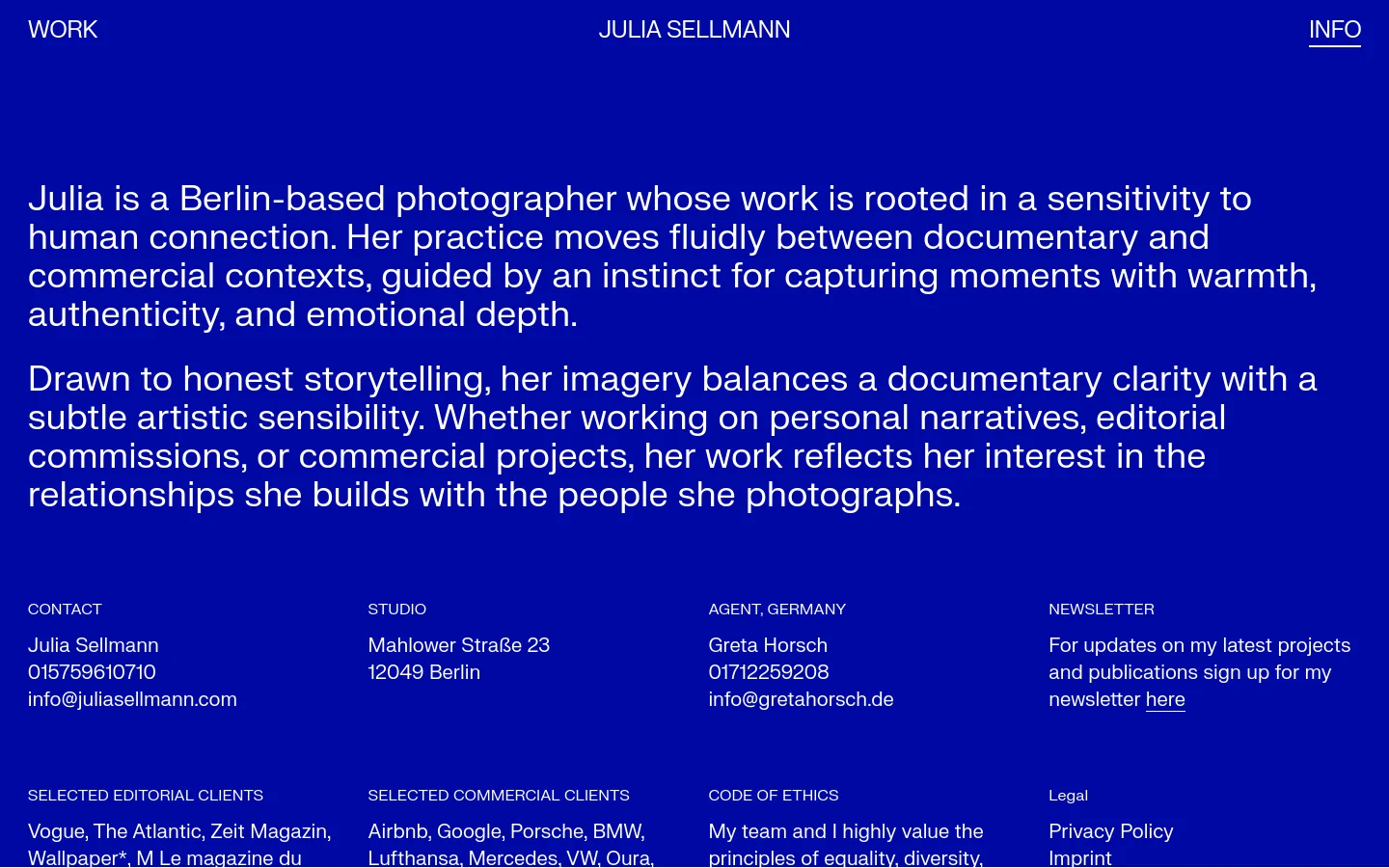The desktop version features a minimalist layout with a deep blue background and white sans-serif text. A large biographical text block dominates the upper half, followed by a multi-column grid containing contact details, studio address, agent information, newsletter signup, client lists, and legal links.