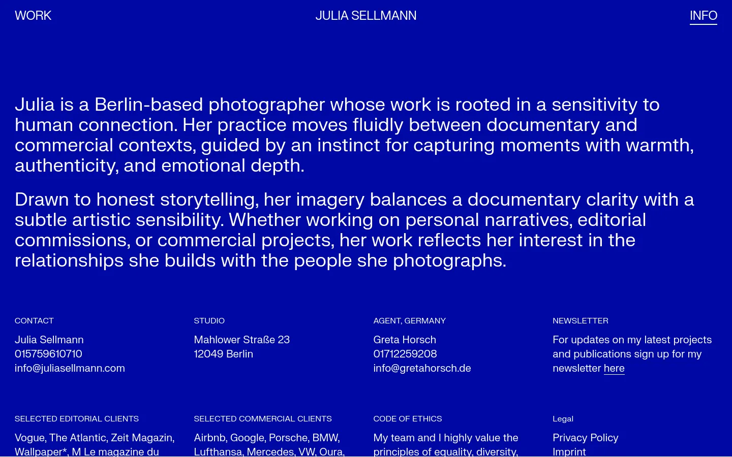 The desktop version features a minimalist layout with a deep blue background and white sans-serif text. A large biographical text block dominates the upper half, followed by a multi-column grid containing contact details, studio address, agent information, newsletter signup, client lists, and legal links.