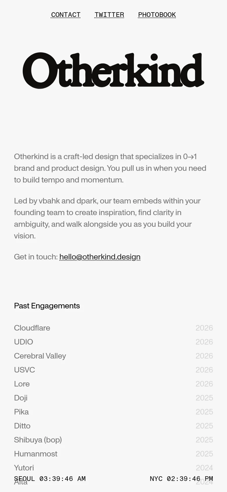 The mobile version maintains the minimalist aesthetic, presenting a centered, large 'Otherkind' logo and stacked text describing the studio. The 'Past Engagements' section is vertically oriented, with company names and years listed in a single column. The layout is simplified for vertical scrolling, with navigation links appearing at the bottom of the screen.