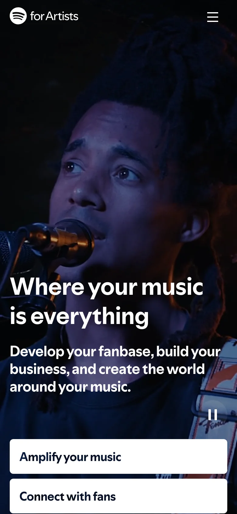 The mobile version displays a vertical layout with a close-up, dark-toned hero image of a musician singing into a microphone. The headline and subheadline are centered over the image, and the navigation menu is collapsed into a hamburger icon in the top right. The bottom navigation options, such as 'Amplify your music' and 'Connect with fans,' are presented as large, stacked white buttons for easy tapping.