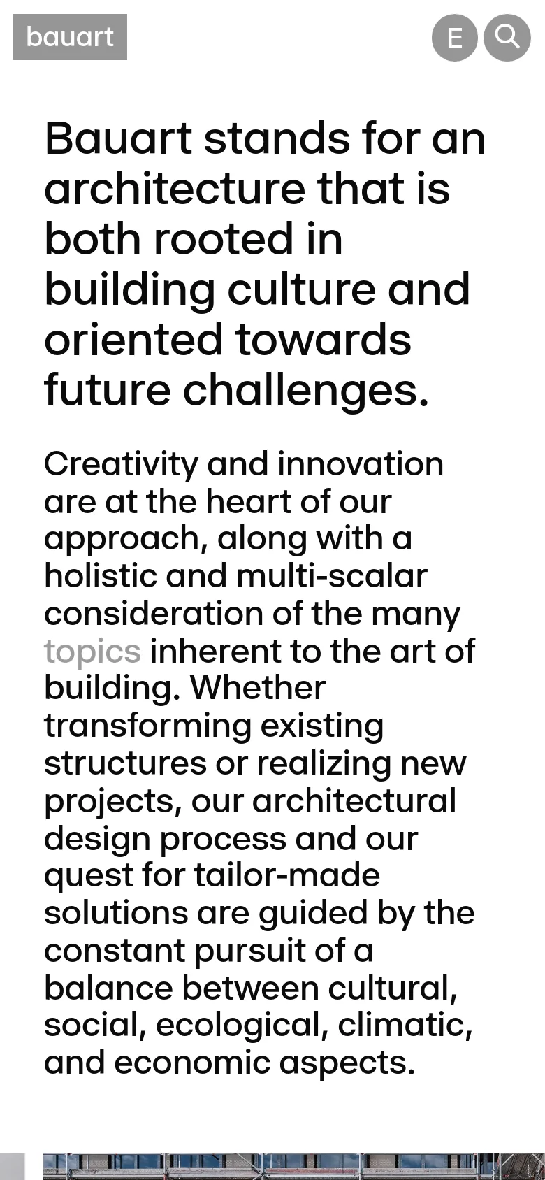 The mobile version presents a vertically stacked layout optimized for small screens, with the navigation menu condensed at the top. The large bold headline and text block occupy the full width of the screen, followed by the architectural image which is scaled to fit the narrower viewport. The overall minimalist aesthetic and high-contrast black text on a white background are maintained.