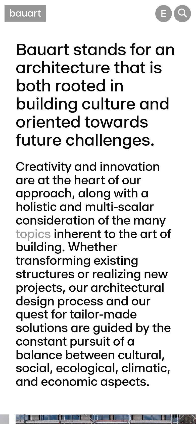 The mobile version presents a vertically stacked layout optimized for small screens, with the navigation menu condensed at the top. The large bold headline and text block occupy the full width of the screen, followed by the architectural image which is scaled to fit the narrower viewport. The overall minimalist aesthetic and high-contrast black text on a white background are maintained.