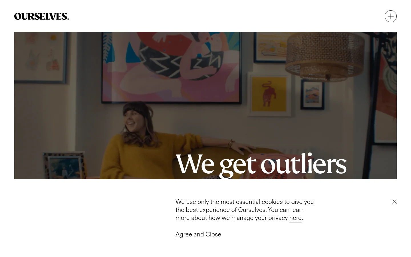 The desktop homepage features a minimalist design with a large hero image of a person in a bright room, overlaid with the bold white headline 'We get outliers'. The 'OURSELVES' logo is in the top left, and a cookie consent banner appears at the bottom. The color palette is warm and natural with soft lighting.