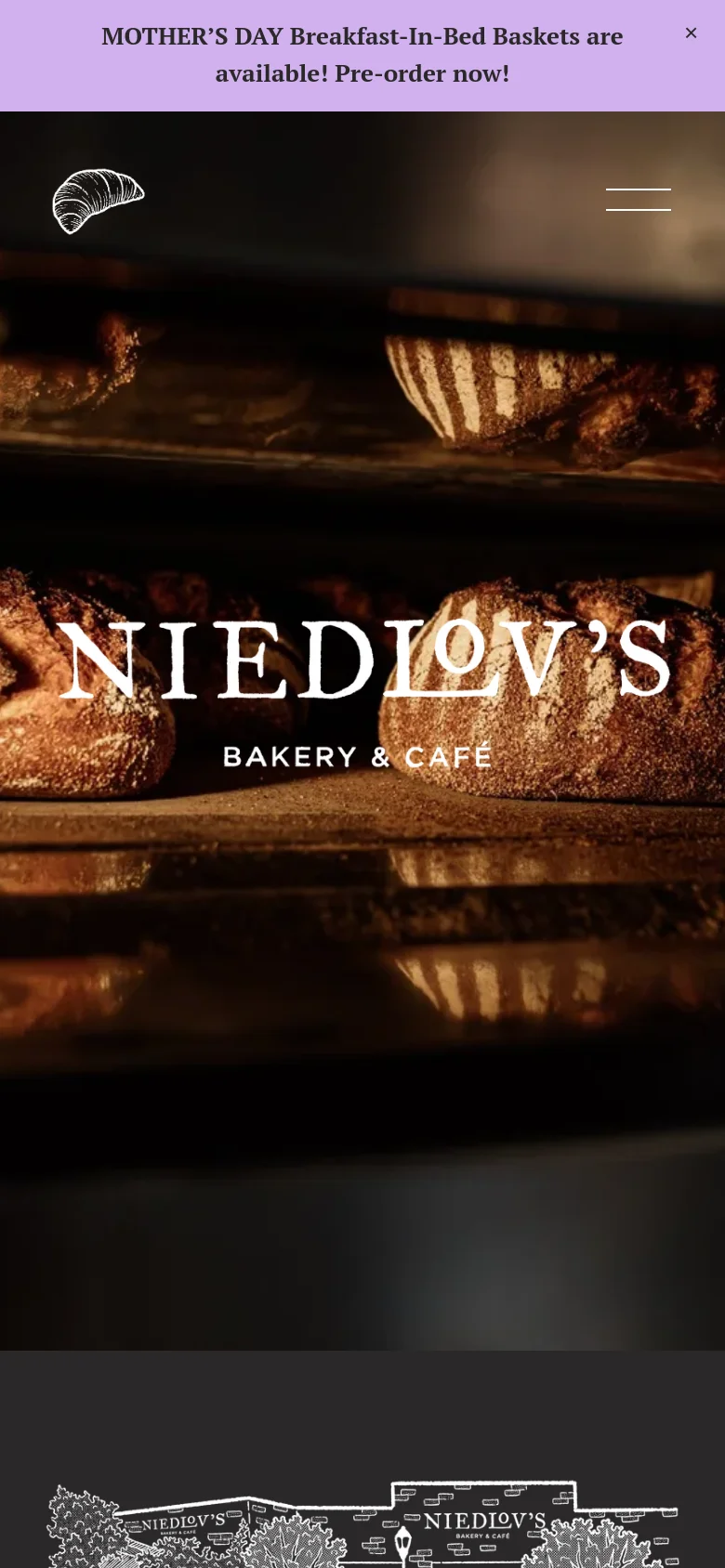 The mobile version presents a vertically stacked layout with a simplified header. The announcement bar remains at the top, followed by a large, centered Niedlov's logo and a hamburger menu icon on the right, all overlaid on the dark, warm-toned bread imagery.
