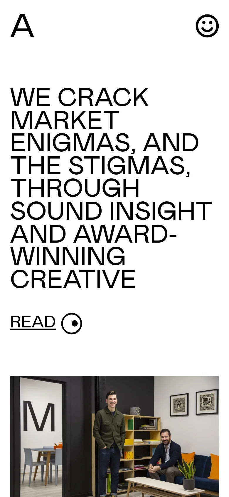 The mobile version presents a vertically stacked layout optimized for small screens. The large bold headline dominates the top of the screen, followed by the 'READ' link and a single-column view of the studio photograph below.