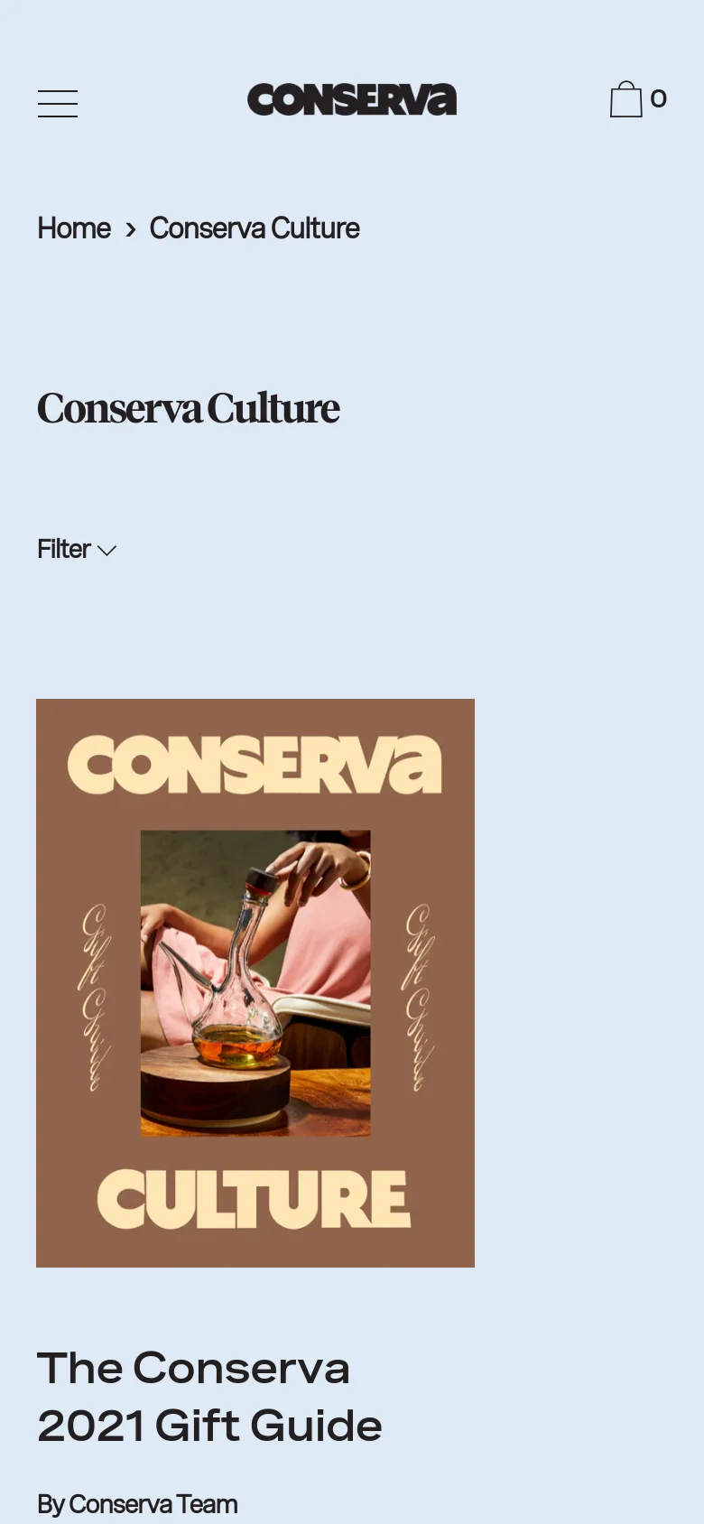 The mobile version simplifies the layout, moving the category filter to a dropdown menu labeled 'Filter' located below the main heading. The hero image and article title, 'The Conserva 2021 Gift Guide,' are stacked vertically, and the navigation is condensed into a hamburger menu icon at the top left.