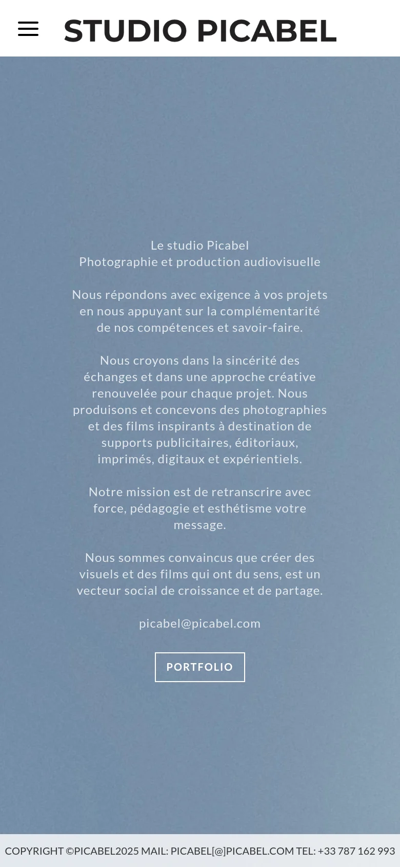 The mobile version uses a simplified vertical layout with a large 'STUDIO PICABEL' header and a hamburger menu icon. The hero section consists of centered white text on a solid blue background, presenting the studio's mission and contact information, with a prominent 'PORTFOLIO' button at the bottom.