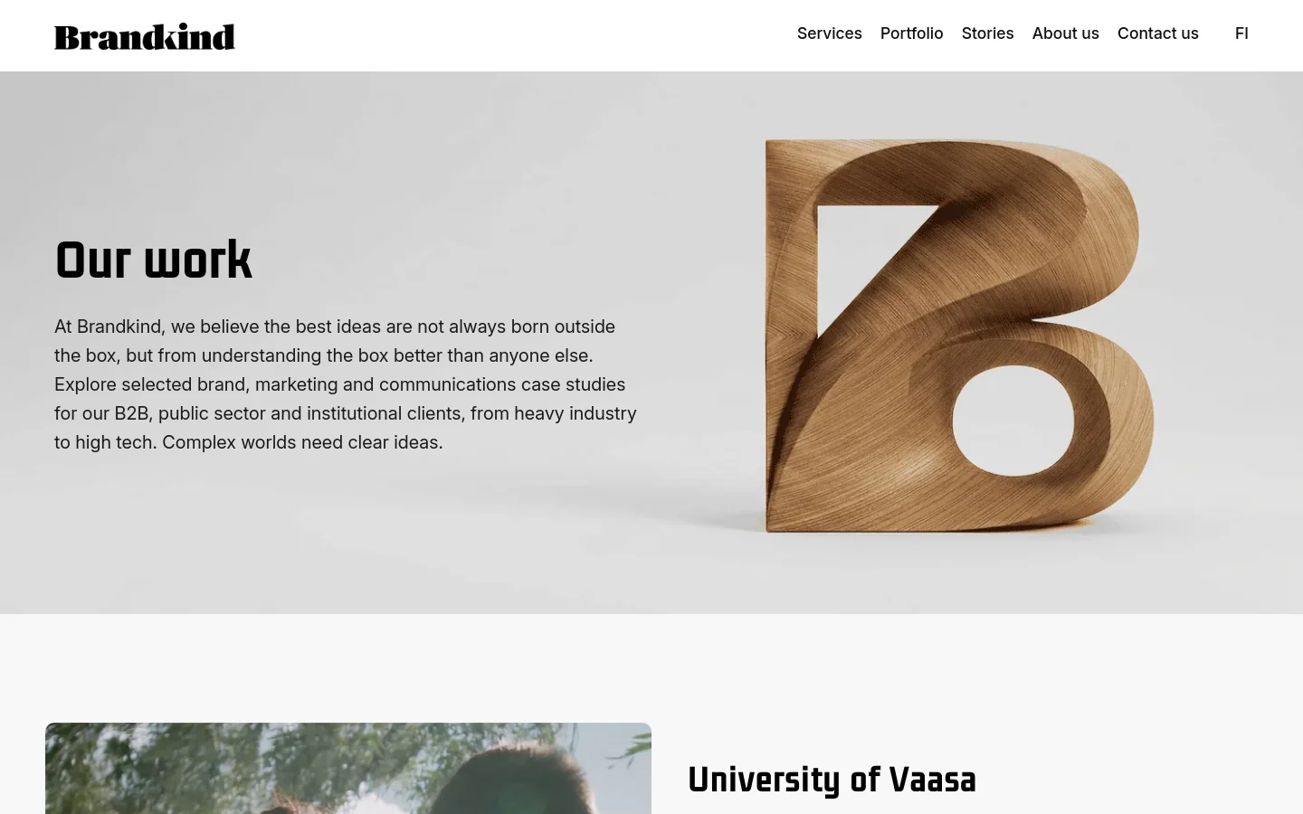 The desktop portfolio page features a large hero section with the headline 'Our work' and a large, 3D wooden 'B' sculpture on a light gray background. Below the hero, a grid of case studies begins, starting with the University of Vaasa, featuring large images, descriptive text, and 'View case study' links. The navigation menu is horizontal at the top right.