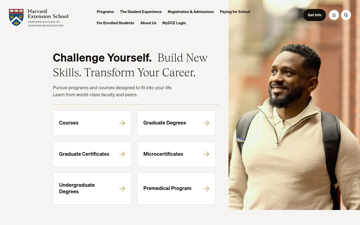 The desktop homepage features a large hero section with a smiling man in a cream sweater against a blurred campus background. The layout includes a bold headline, 'Challenge Yourself. Build New Skills. Transform Your Career.', followed by a grid of white navigation cards for Courses, Graduate Degrees, Graduate Certificates, Microcertificates, Undergraduate Degrees, and the Premedical Program. The header contains the Harvard Extension School logo, navigation links, and a prominent black 'Get Info' button.