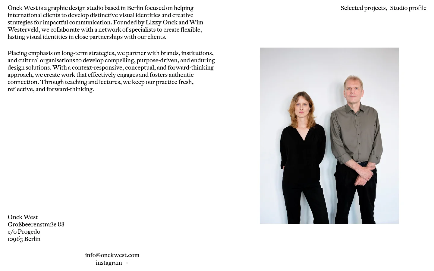The desktop page features a minimalist layout with black text on a white background. On the left, two columns of text describe the studio's mission and contact information, while the right side displays a large portrait of the founders, Lizzy Onck and Wim Westerveld, standing against a light grey wall. Navigation links for 'Selected projects' and 'Studio profile' are positioned at the top right.