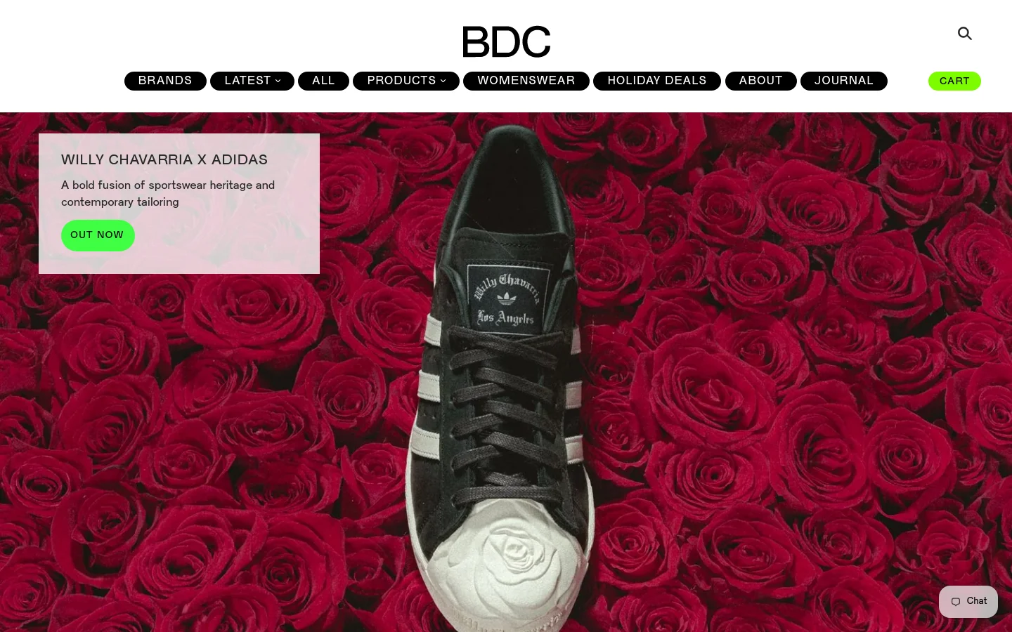 The desktop homepage features a minimalist white header with the BDC logo and a navigation menu containing links like Brands, Latest, and Products. A large hero banner showcases a black Adidas sneaker centered against a dense background of red roses, with a pink text box on the left promoting 'WILLY CHAVARRIA X ADIDAS' and an 'OUT NOW' button. Below the hero, a 'NEW ITEMS' section displays a grid of high-end fashion products.