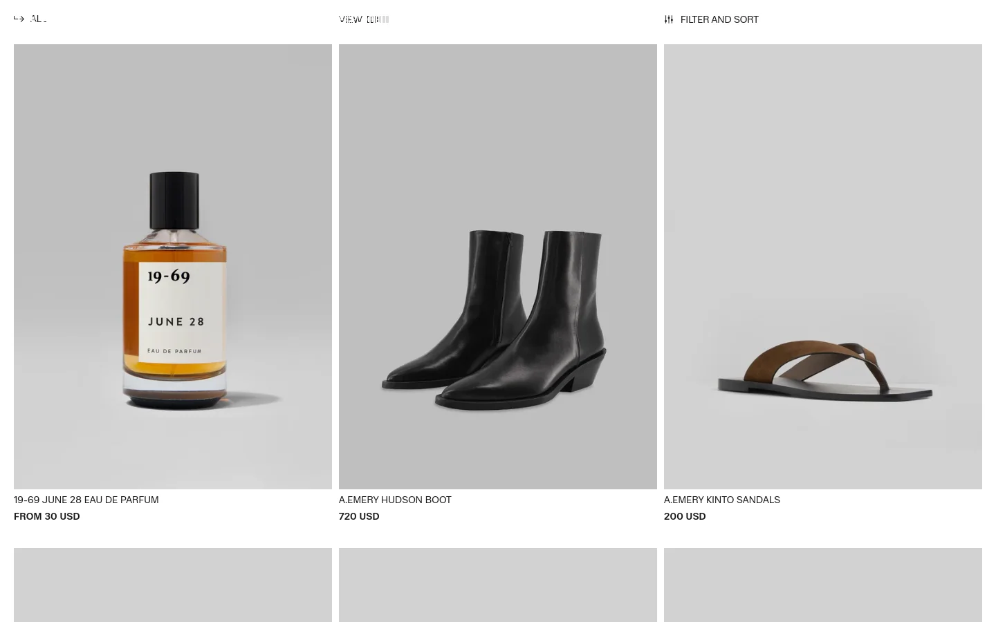 The desktop view shows a minimalist fashion collection page with a white background and a grid of product images. Products include a perfume bottle, black leather boots, and brown sandals, each displayed against a neutral grey background with text below indicating the product name and price. A top navigation bar includes options for 'VIEW' and 'FILTER AND SORT'.