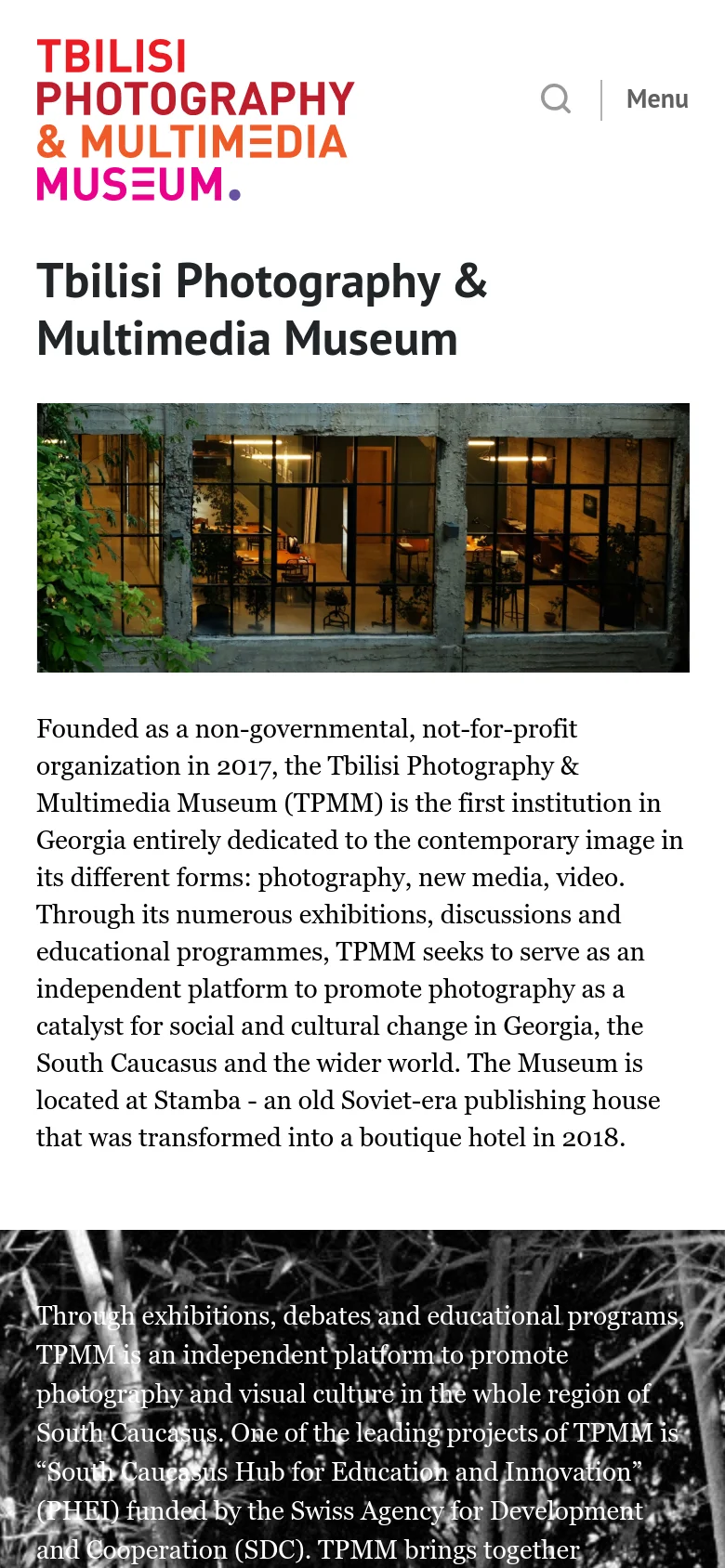 The mobile version uses a vertical layout with the museum logo prominently at the top, accompanied by a search icon and a 'Menu' button. The main headline and a large landscape image of the museum building follow, with the descriptive text flowing underneath in a single column for easier scrolling.