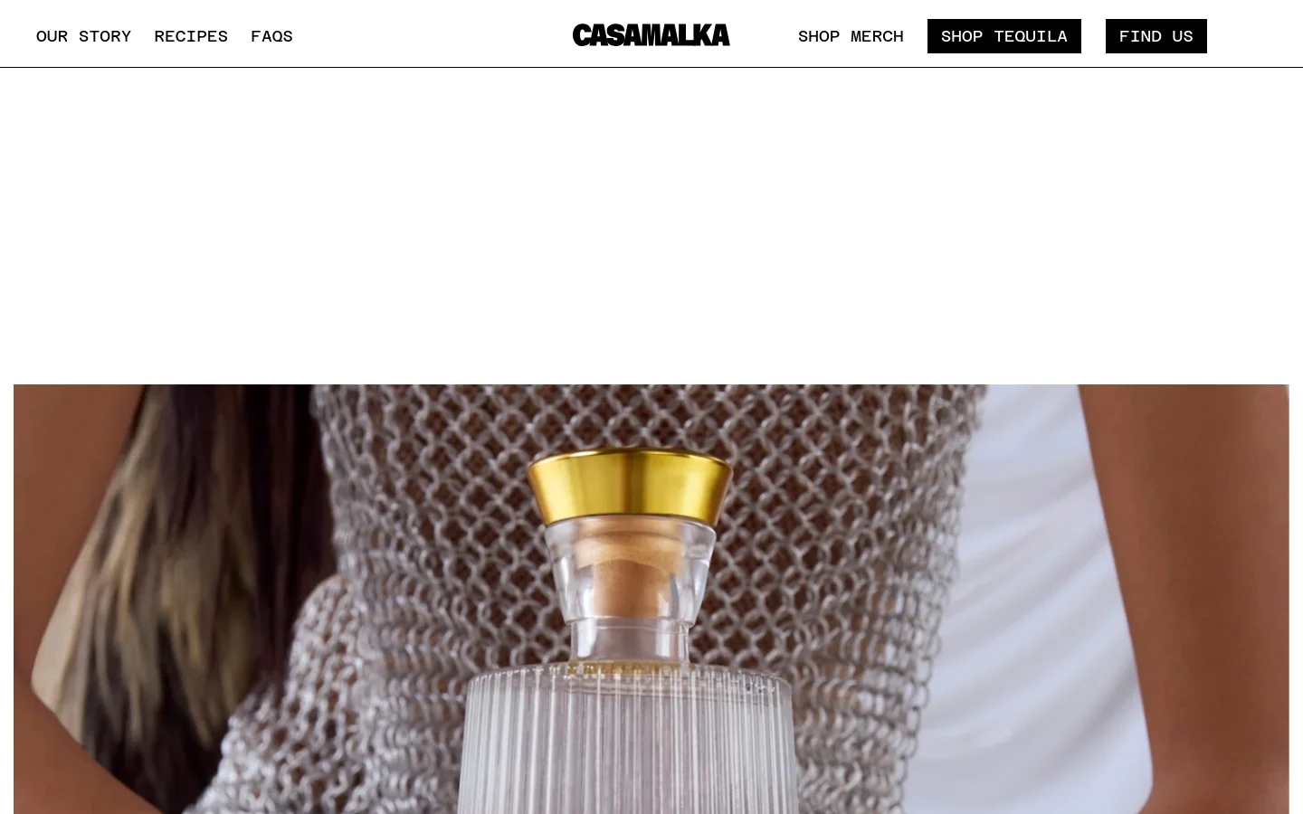 The desktop page features a clean white header with the Casa Malka logo centered between navigation links and black call-to-action buttons for 'Shop Tequila' and 'Find Us'. Below the header, a large hero image shows a person in a silver mesh top holding a clear, textured Casa Malka tequila bottle with a gold cap. The headline 'Welcome To The Queendom' is prominently displayed in large, bold black typography.