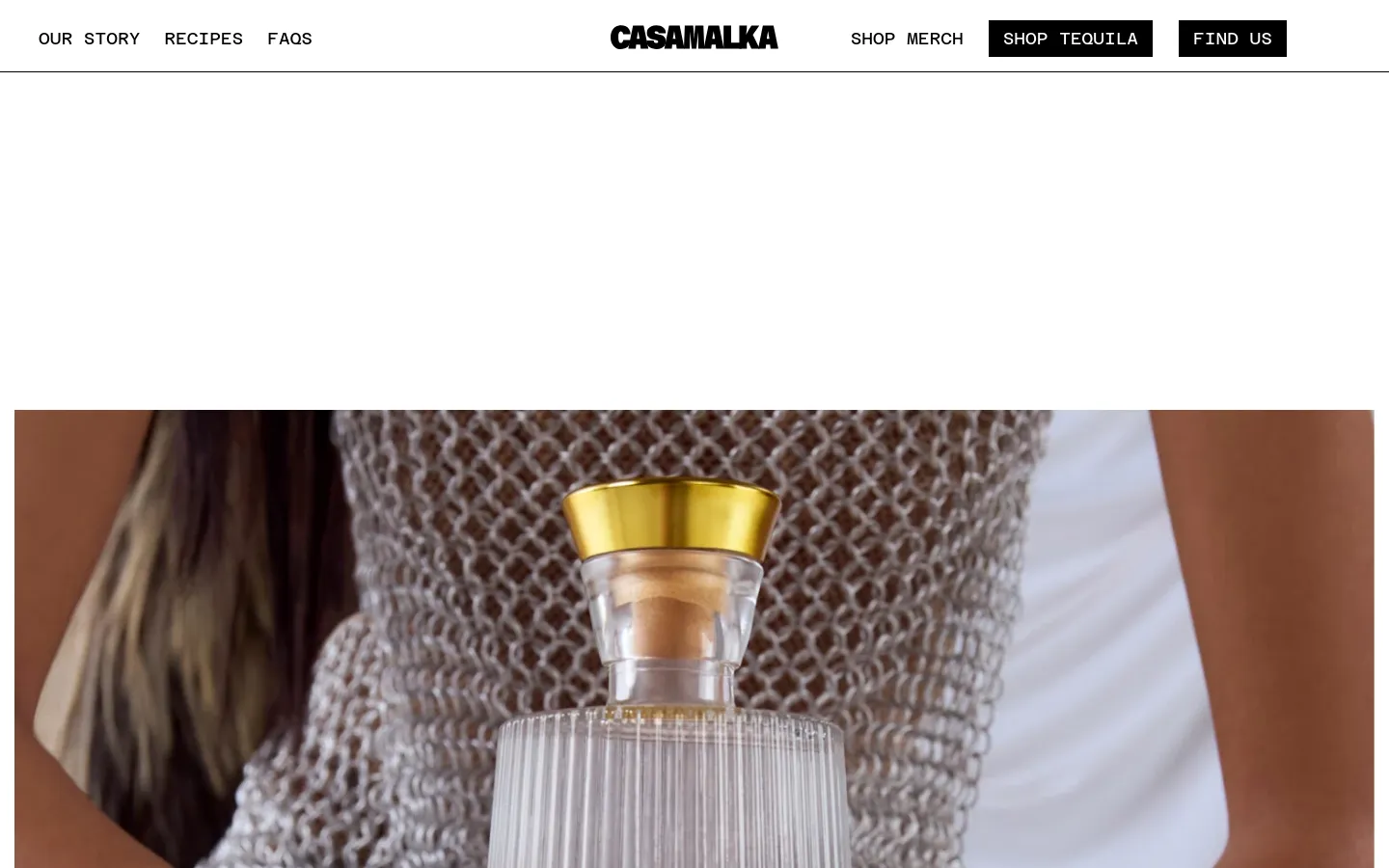 The desktop page features a clean white header with the Casa Malka logo centered between navigation links and black call-to-action buttons for 'Shop Tequila' and 'Find Us'. Below the header, a large hero image shows a person in a silver mesh top holding a clear, textured Casa Malka tequila bottle with a gold cap. The headline 'Welcome To The Queendom' is prominently displayed in large, bold black typography.