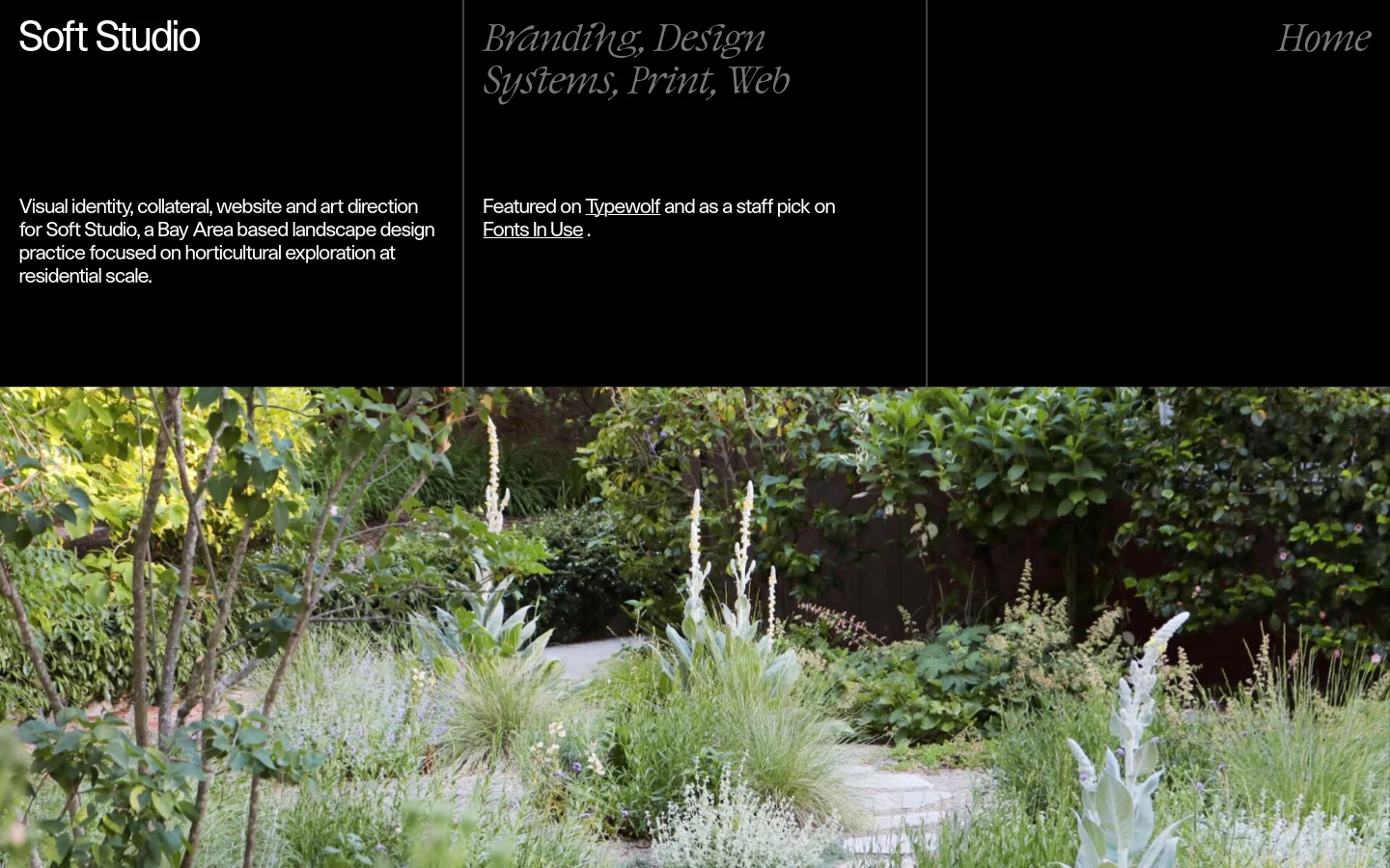 The desktop view features a black background with white serif typography arranged in a grid-like layout. The top row contains the title 'Soft Studio', the services 'Branding, Design Systems, Print, Web', and a 'Home' link, while the second row contains a project description and mentions of Typewolf and Fonts In Use. A large, full-width hero image of a lush, green residential garden with white flowering plants sits at the bottom of the frame.