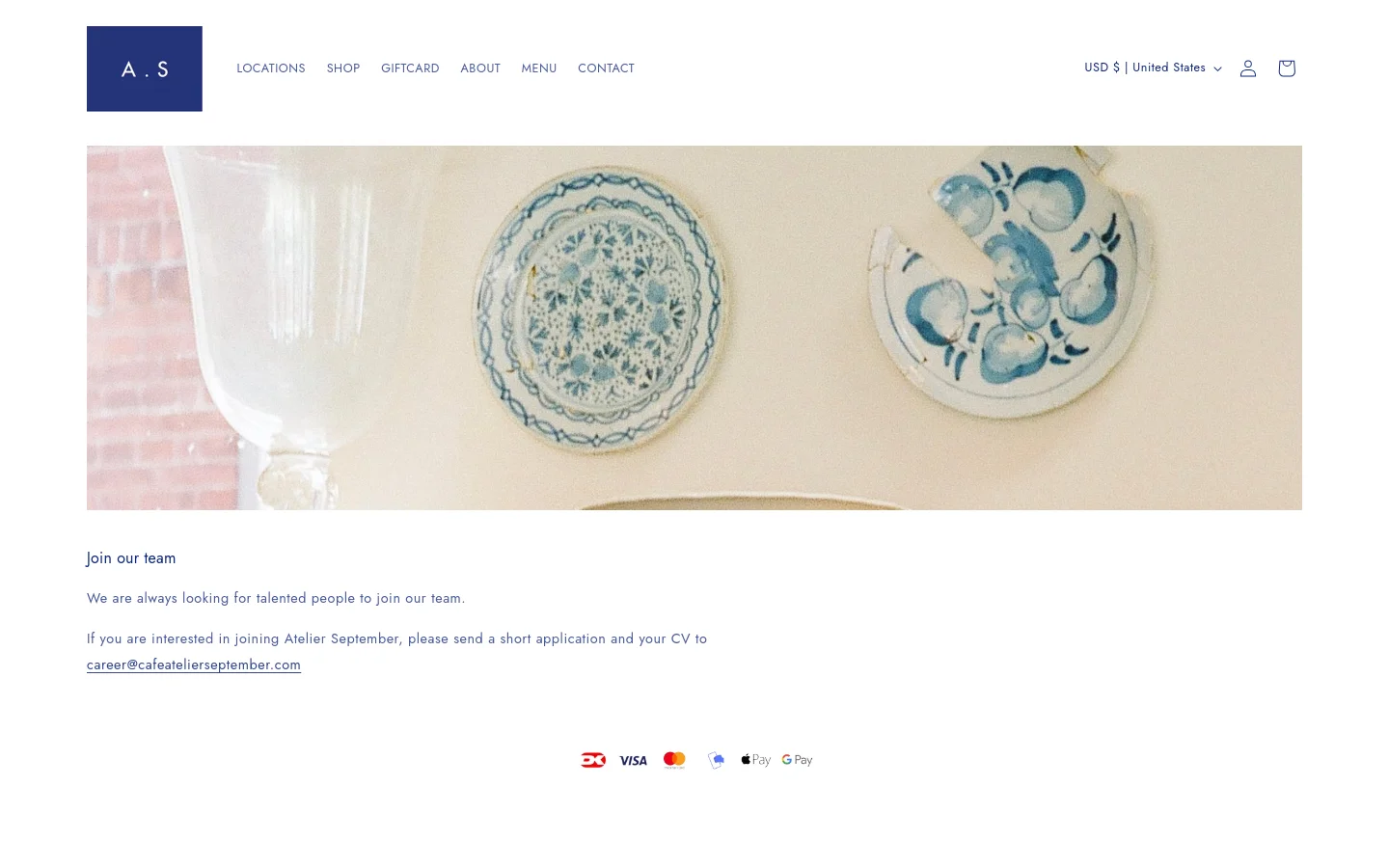 The desktop page features a minimalist layout with a large hero image of blue and white patterned ceramics and glassware on a wooden surface. A clean white header contains the 'A.S' logo, navigation links like Locations and Shop, and a shopping bag icon. Below the image, the headline 'Join our team' is followed by text inviting applicants to email their CV to a specified career address.