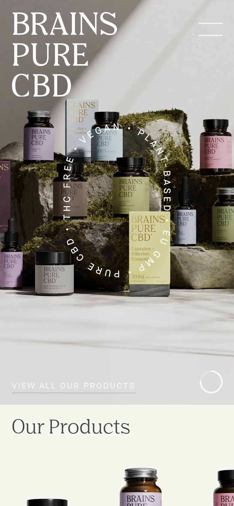 The mobile version simplifies the layout, centering the 'BRAINS PURE CBD' logo and replacing the desktop navigation with a hamburger menu icon. The hero image of CBD products on mossy rocks remains the focal point, with the 'VIEW ALL OUR PRODUCTS' call to action positioned at the bottom of the screen.