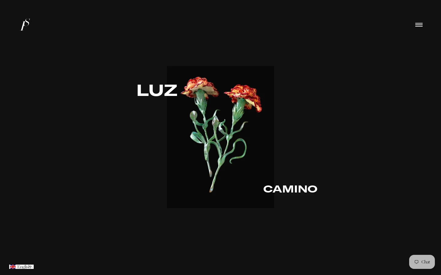 The desktop landing page features a minimalist black background with a central hero image of two red carnations on green stems. The large white text 'LUZ' is positioned to the left of the image, and 'CAMINO' is positioned to the right, creating a balanced, high-contrast composition. A small white logo is in the top left corner and a hamburger menu icon is in the top right.